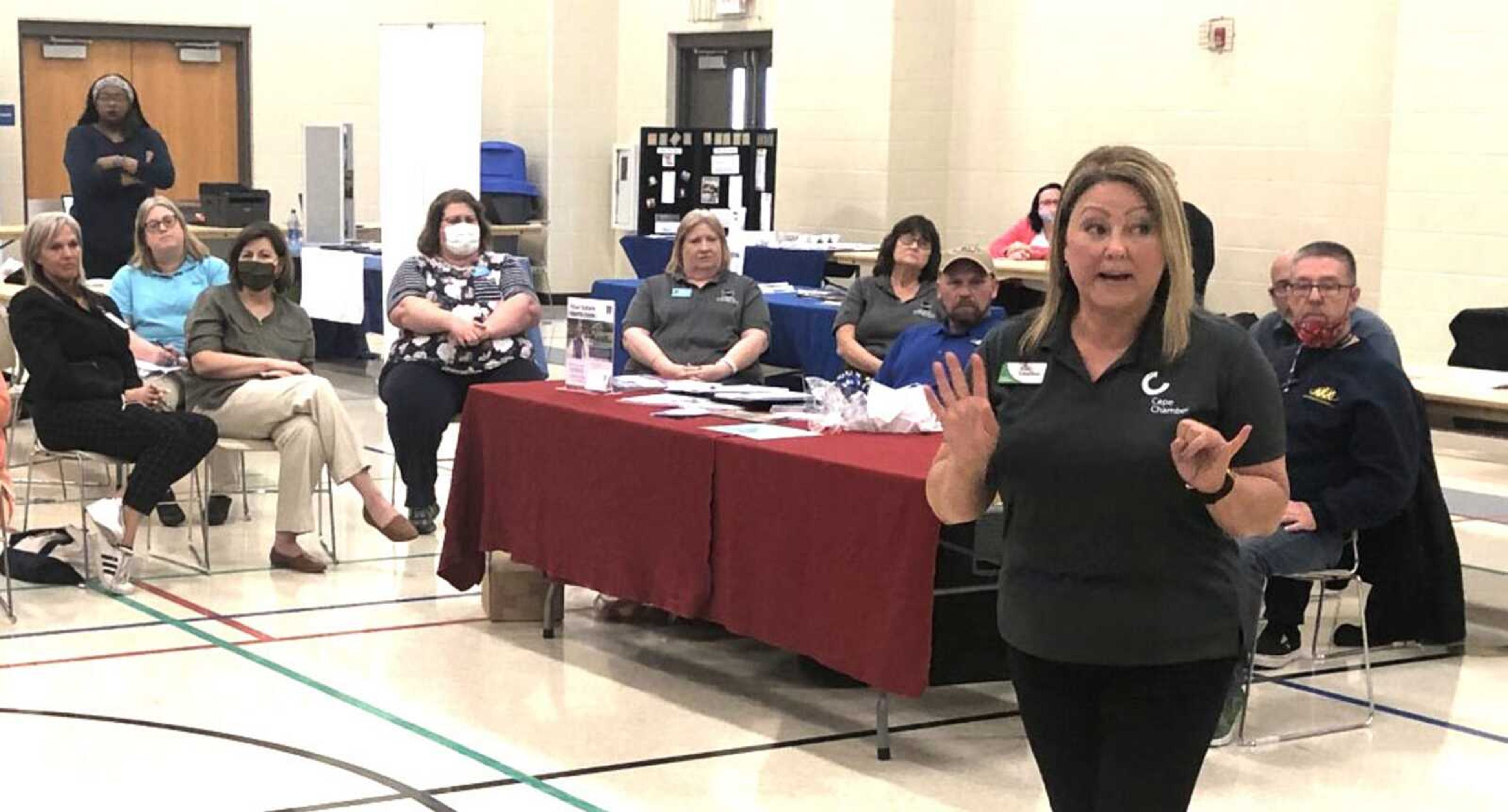 Cape Girardeau Area Chamber of Commerce vice president Kim Voelker speaks with a group of local employers and agency representatives about the challenges they face hiring and retaining employees before the Project C.A.P.E. job fair Thursday at Shawnee Community Center in Cape Girardeau.