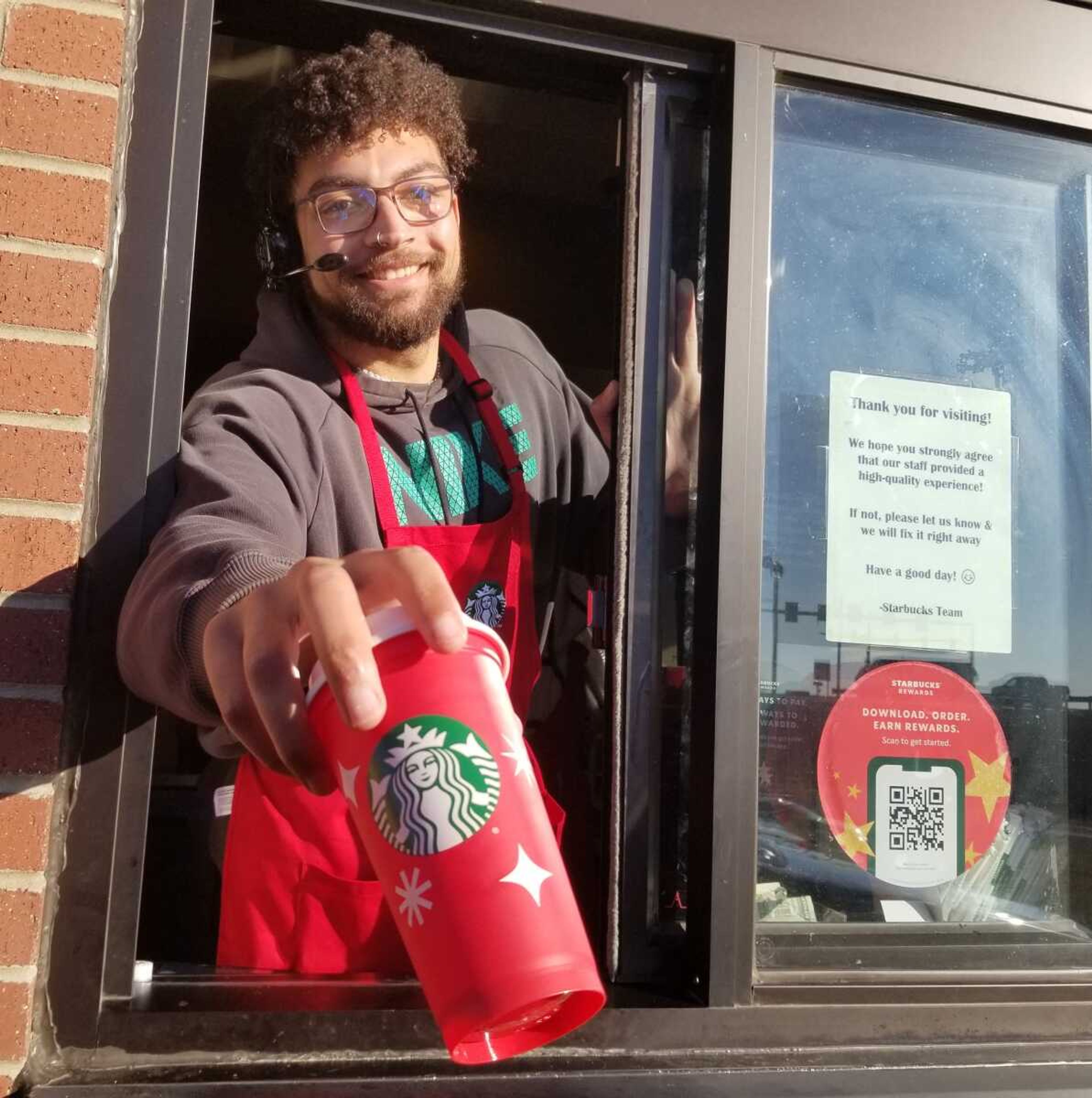 Barista Coleton Gabriel hands a commemorative red cup to a patron Thursday, Nov. 17, at the Starbucks, 188 Vantage Drive, near the Interstate 55 and William Street intersection in Cape Girardeau. The Cape Girardeau location was not among the 112 U.S. Starbucks stores that witnessed a one-day strike by employees on "Red Cup Day".