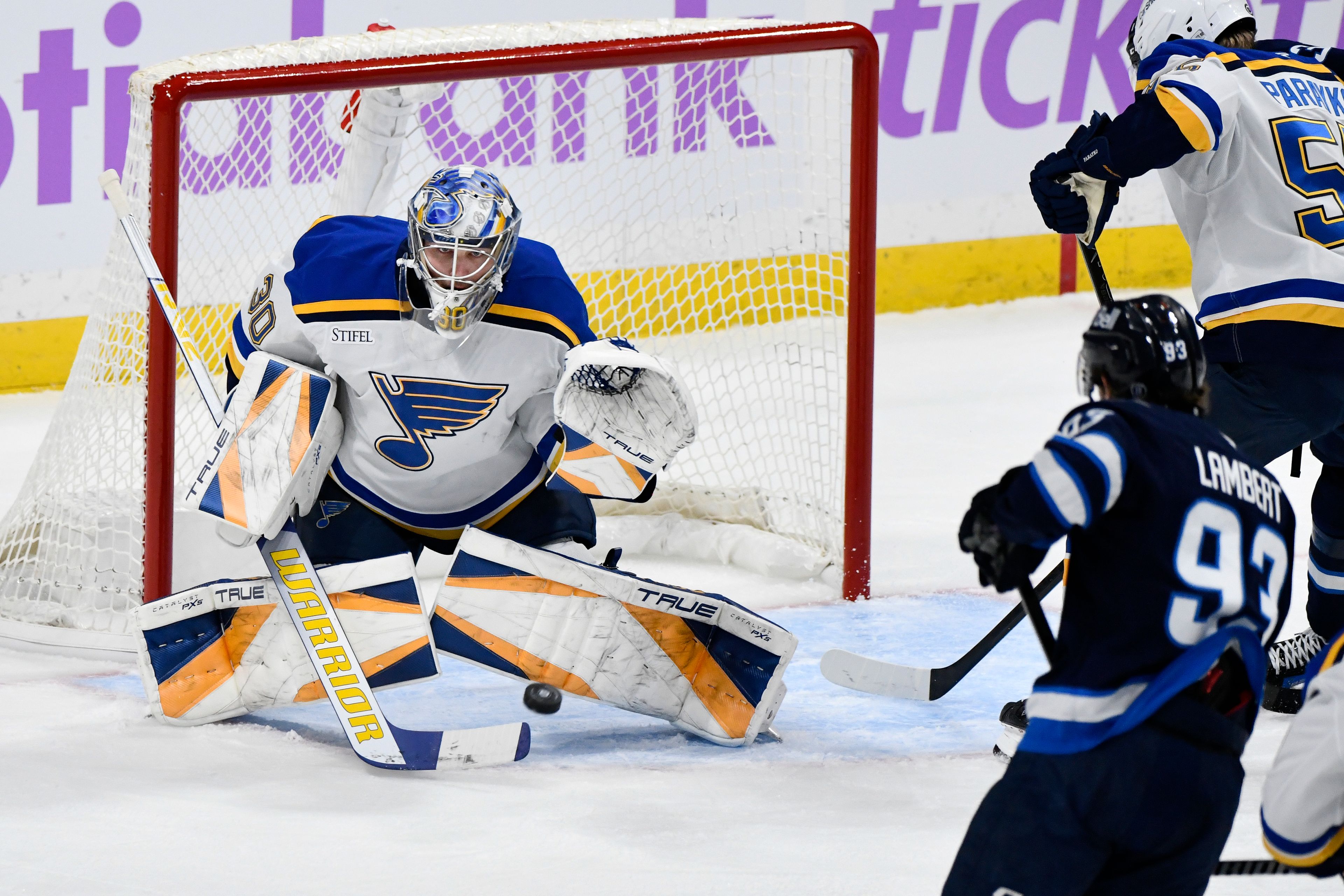 St. Louis Blues goaltender Joel Hofer (30) makes a save on a Winnipeg Jets shot during the first period of their NHL hockey game in Winnipeg, Tuesday December 3, 2024. (Fred Greenslade/The Canadian Press via AP)