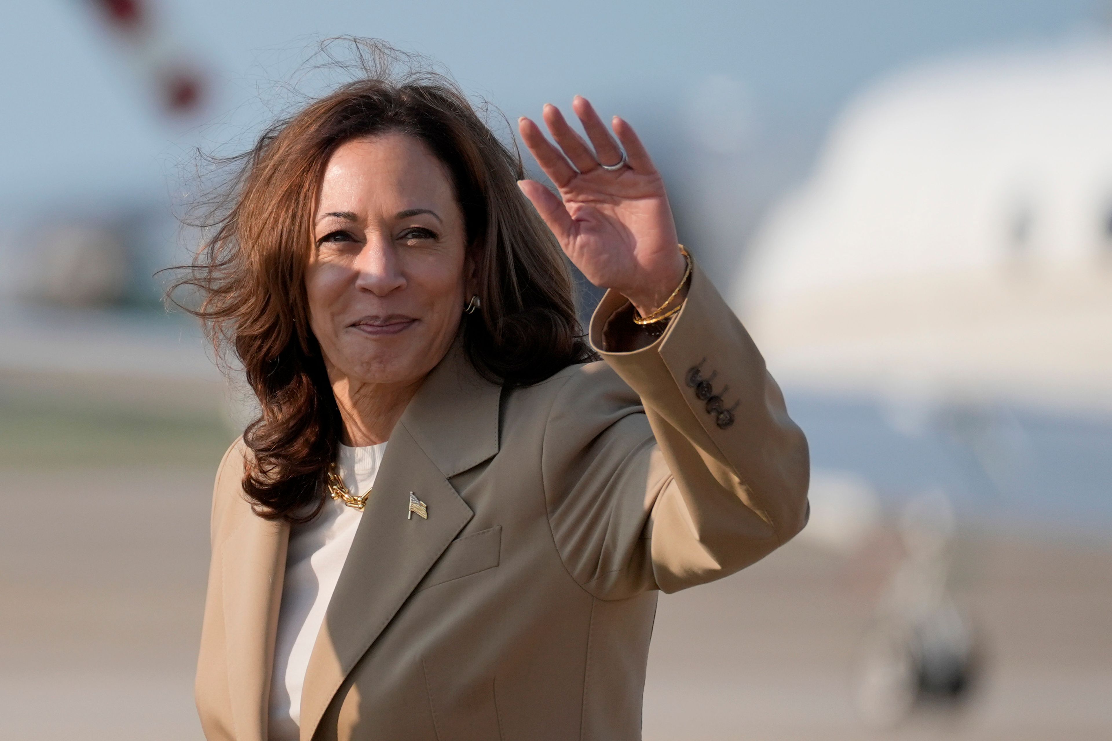 Vice President Kamala Harris waves upon arrival at Andrews Air Force Base in Md., Saturday, July 27, 2024. Harris is returning to Washington after participating in a political event in Pittsfield, Mass. (AP Photo/Stephanie Scarbrough, Pool)