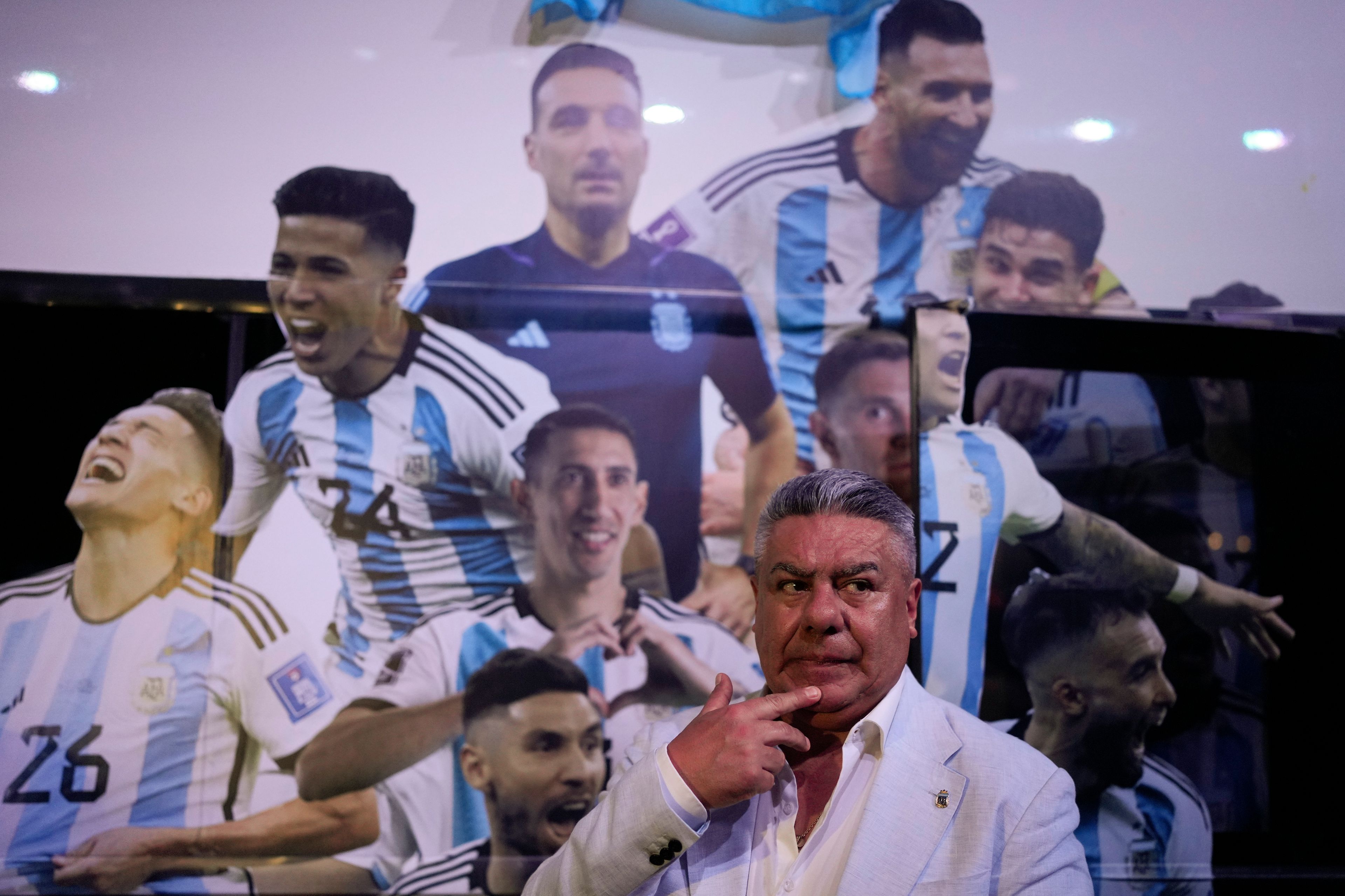 FILE - Claudio Tapia, president of the Argentina Soccer Association or AFA, backdropped by a bus banner of featuring World Cup 2022 team players, attends the "World Champions" exhibit in Buenos Aires, Argentina, April 5, 2023. (AP Photo/Natacha Pisarenko, File)