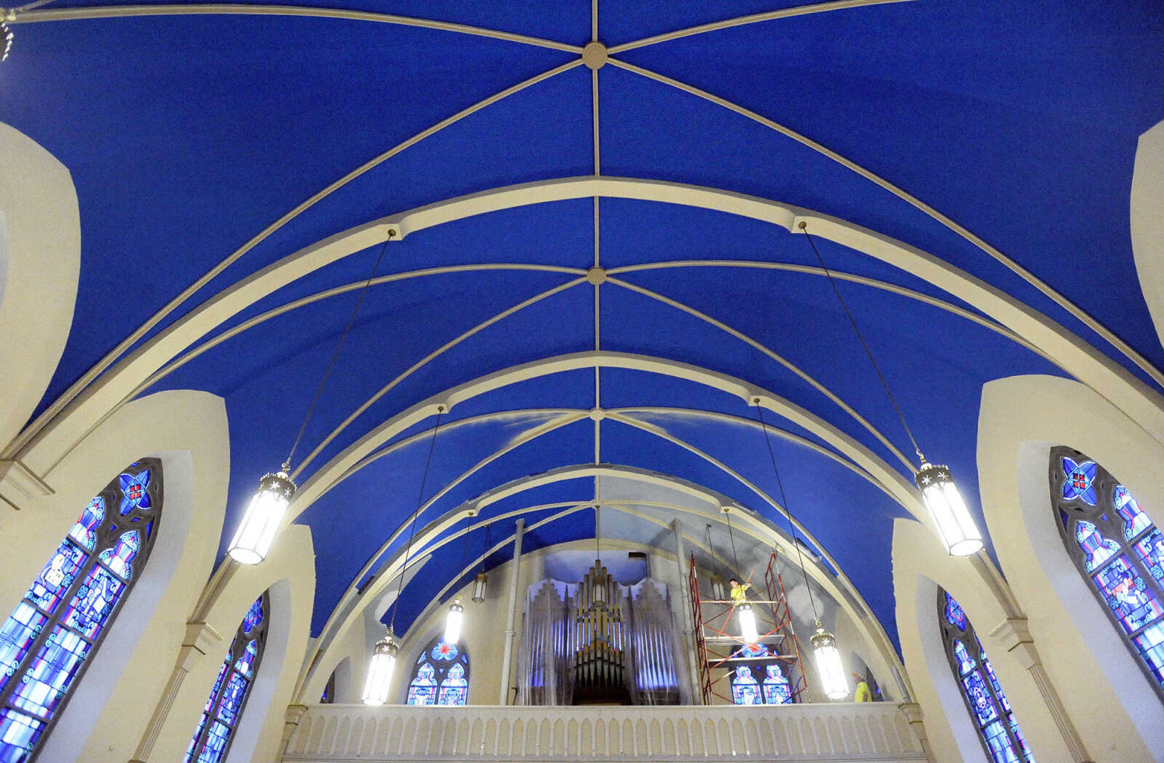 LAURA SIMON ~ lsimon@semissourian.com

Kyle Thompson braces himself atop the scaffolding in the choir loft as he paints the ceiling inside St. John's Catholic Church in Leopold, Missouri on March 4, 2016.