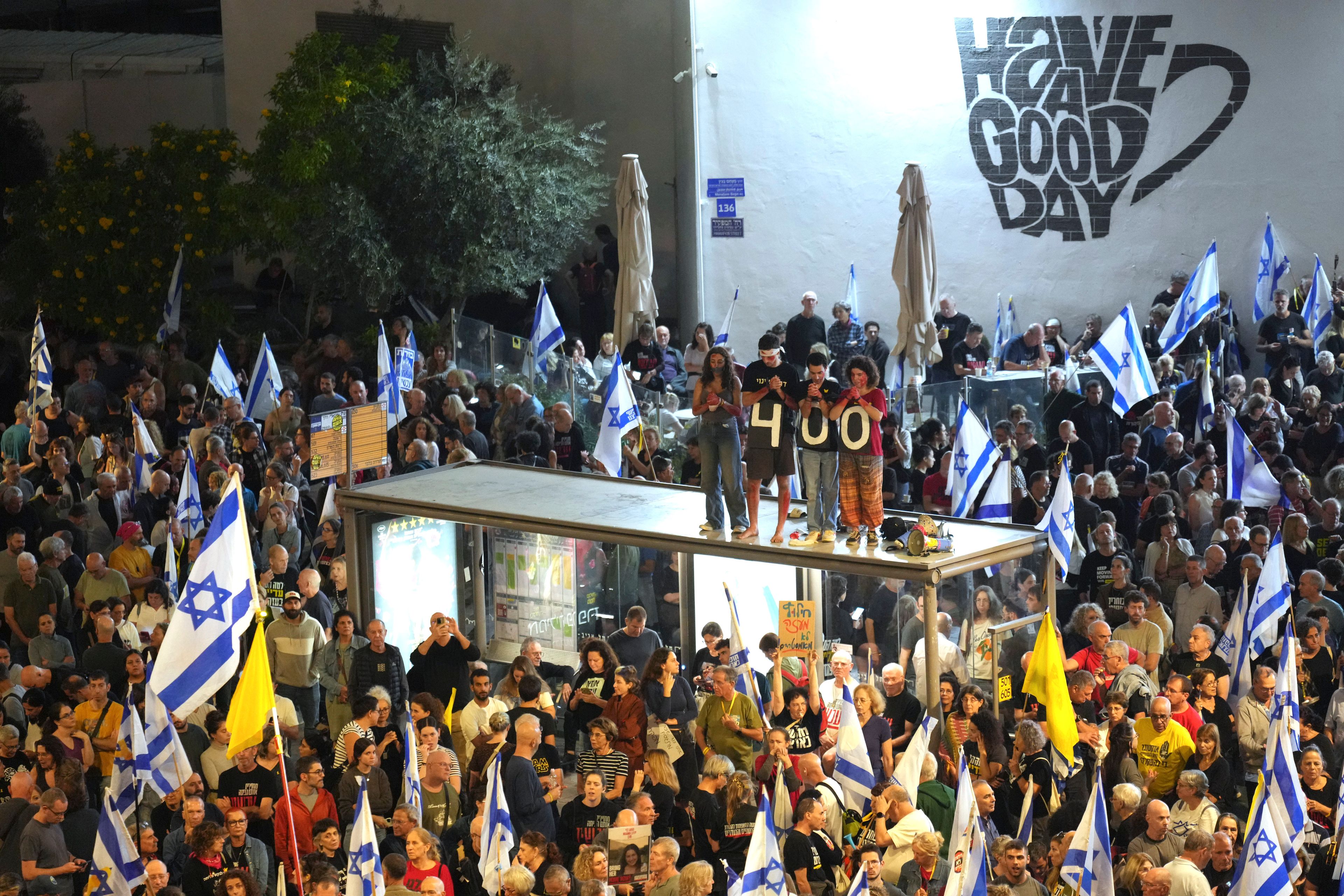 People protest against Prime Minister Benjamin Netanyahu's government in Tel Aviv, Israel, Saturday, Nov. 9, 2024, and call for the release of hostages held in the Gaza Strip by the Hamas militant group, marking 400 days since their capture. (AP Photo/Ohad Zwigenberg)