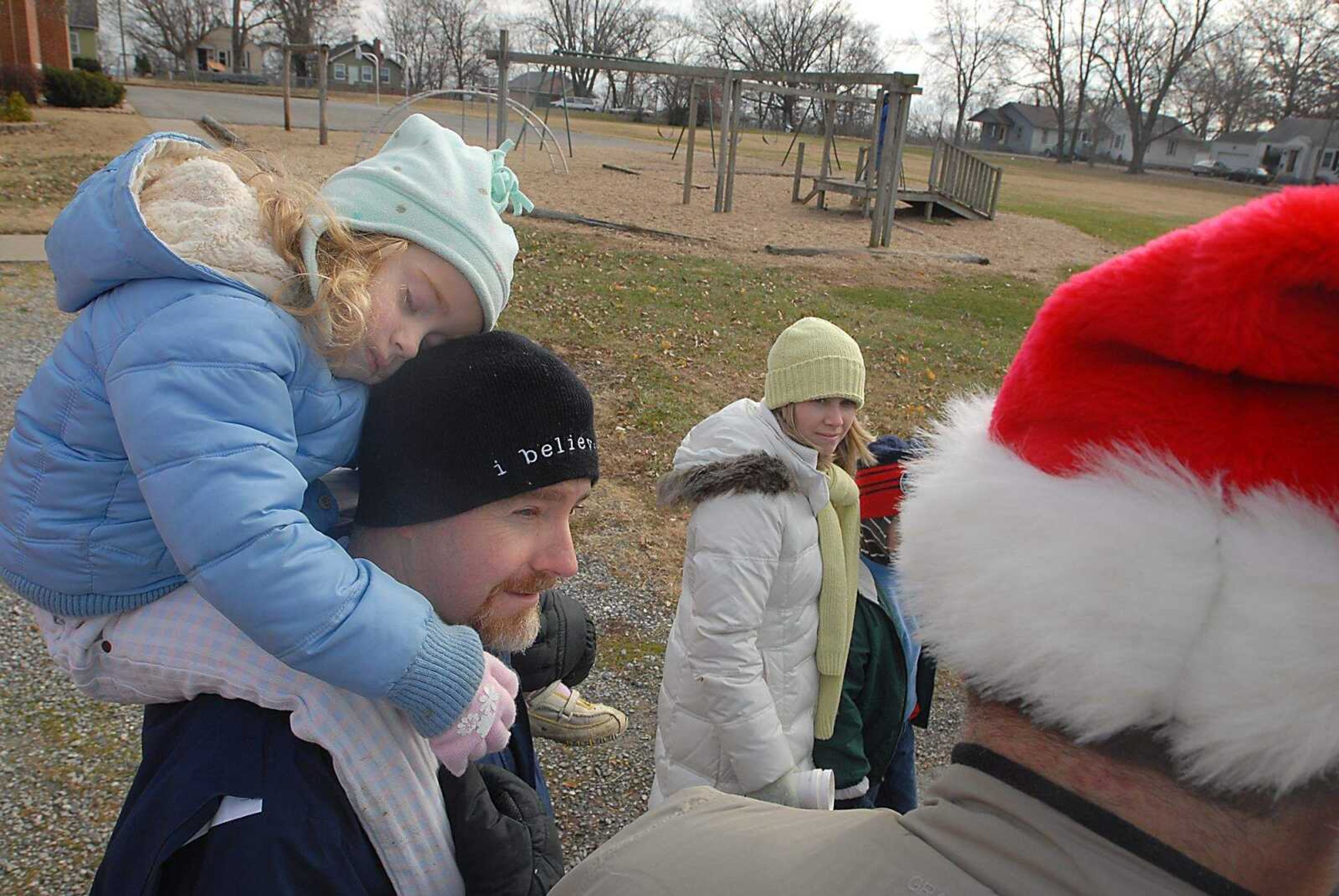 KIT DOYLE ~ kdoyle@semissourian.com
Russell Grammer carries his sleeping daughter Sarah, 4, while marching Saturday, December 6, 2008, along Ranney St. in Cape Girardeau. Grammer was one of several staff members from Jefferson Elementary to take part in the march.