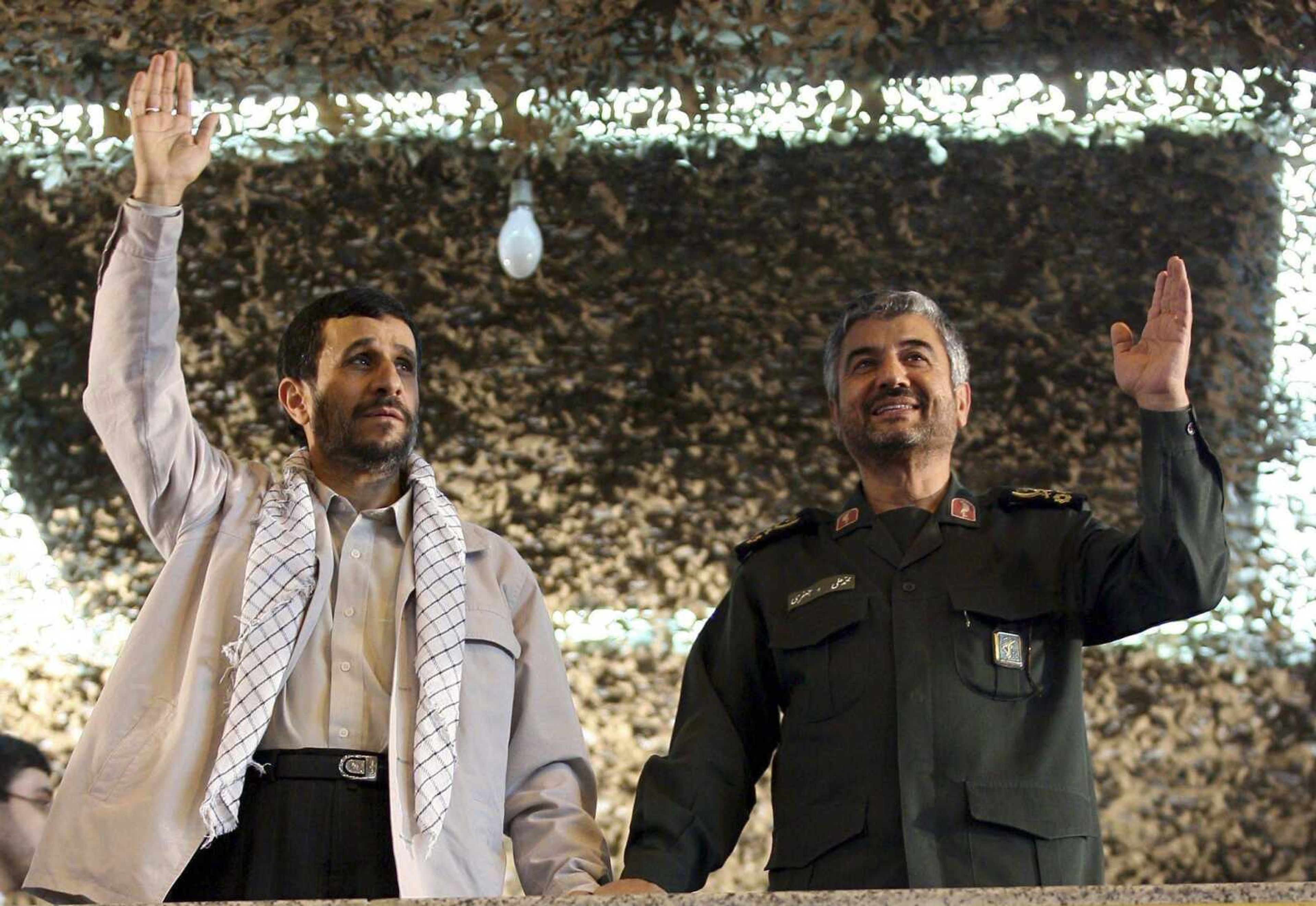 Iranian President Mahmoud Ahmadinejad, left, and the Head of Revolutionary Guards, commander Mohammad Ali Jafari wave Oct. 30, 2007, as they attend a ceremony in Tehran, Iran. (Associated Press file)