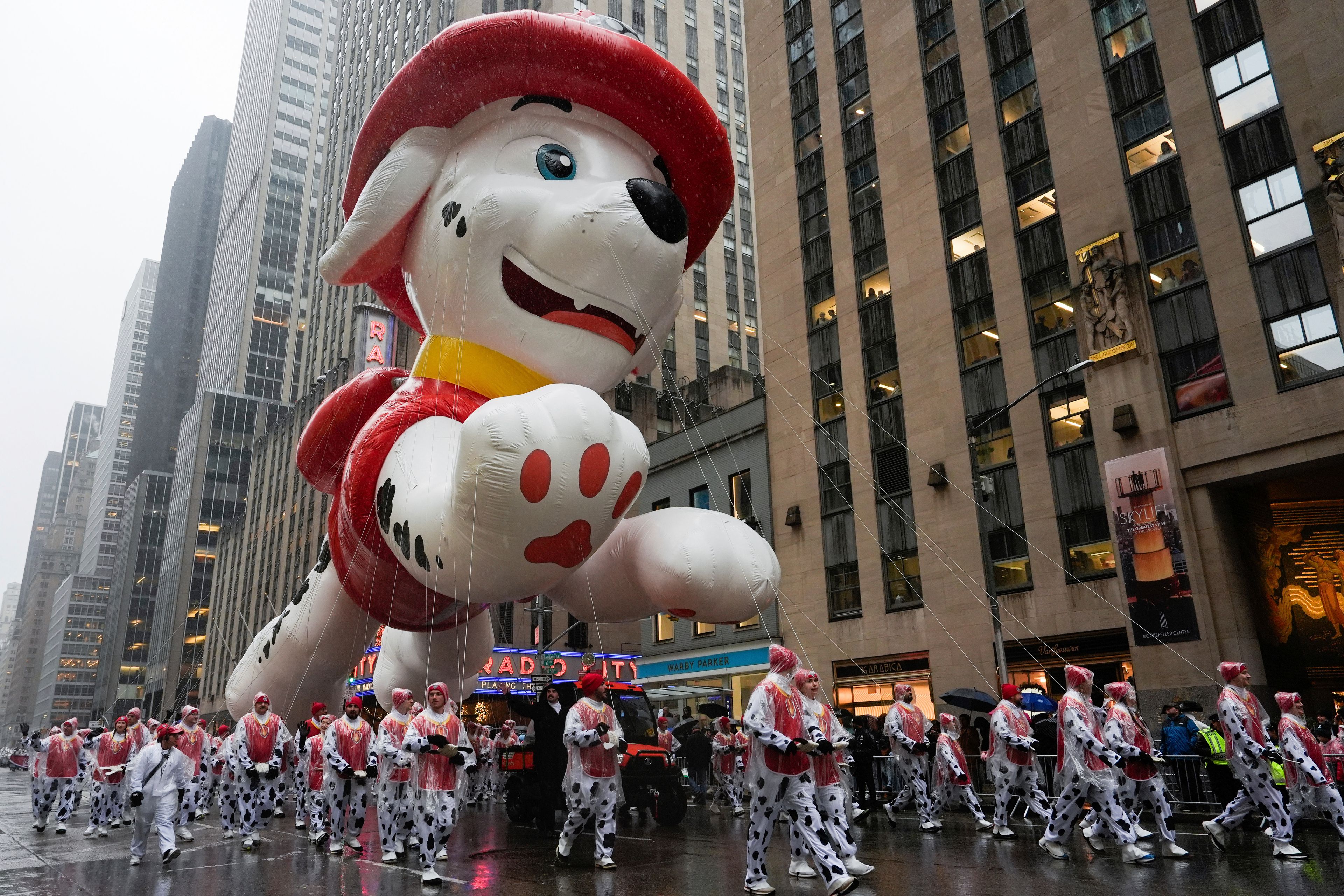 Handlers guide the Marshall from PAW Patrol balloon down Sixth Avenue during the Macy's Thanksgiving Day Parade, Thursday, Nov. 28, 2024, in New York. (AP Photo/Julia Demaree Nikhinson)