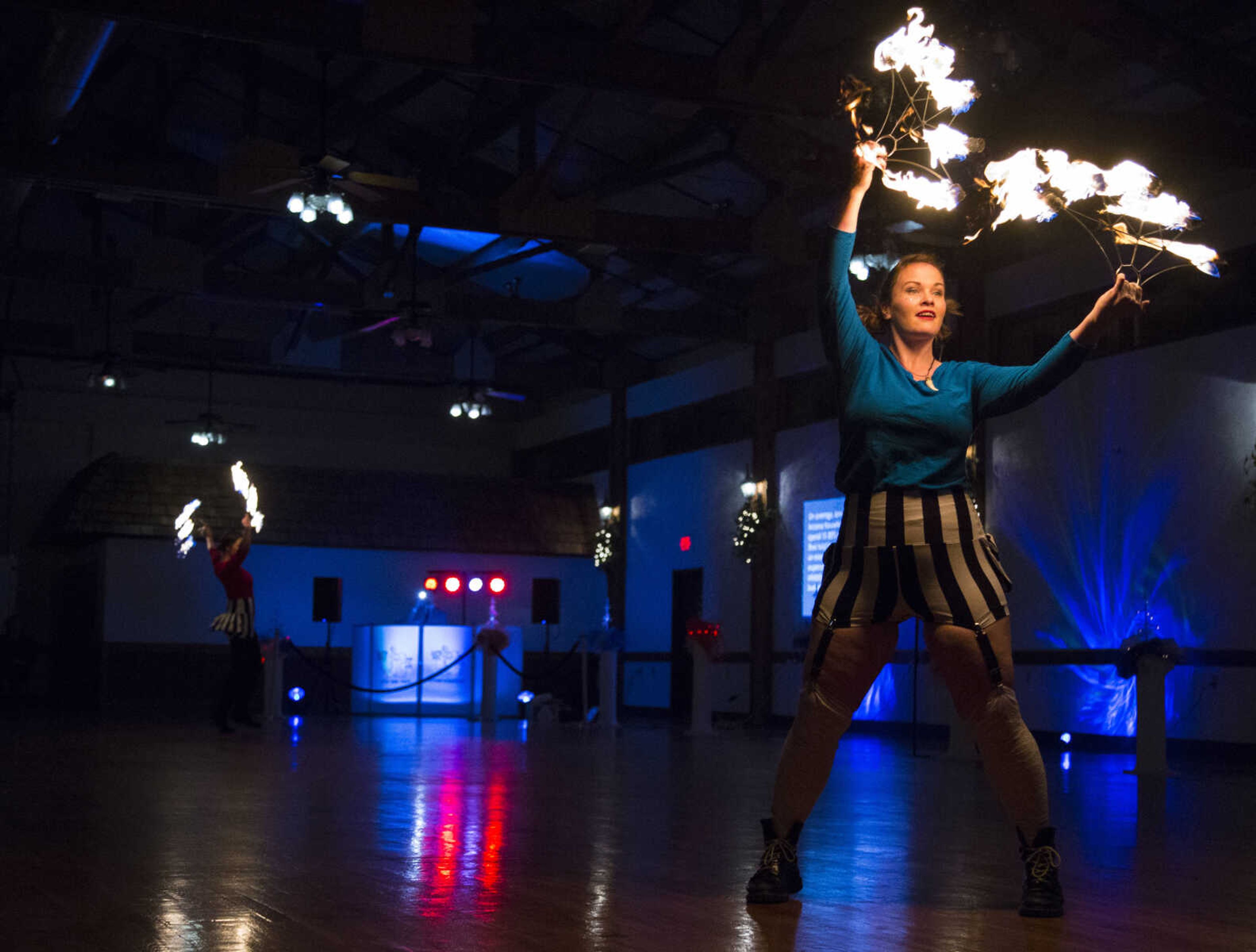 Honora Kinsella dances with fire Saturday, Feb. 3, 2018, during the Fire and Ice Gala at Bavarian Halle in Jackson.