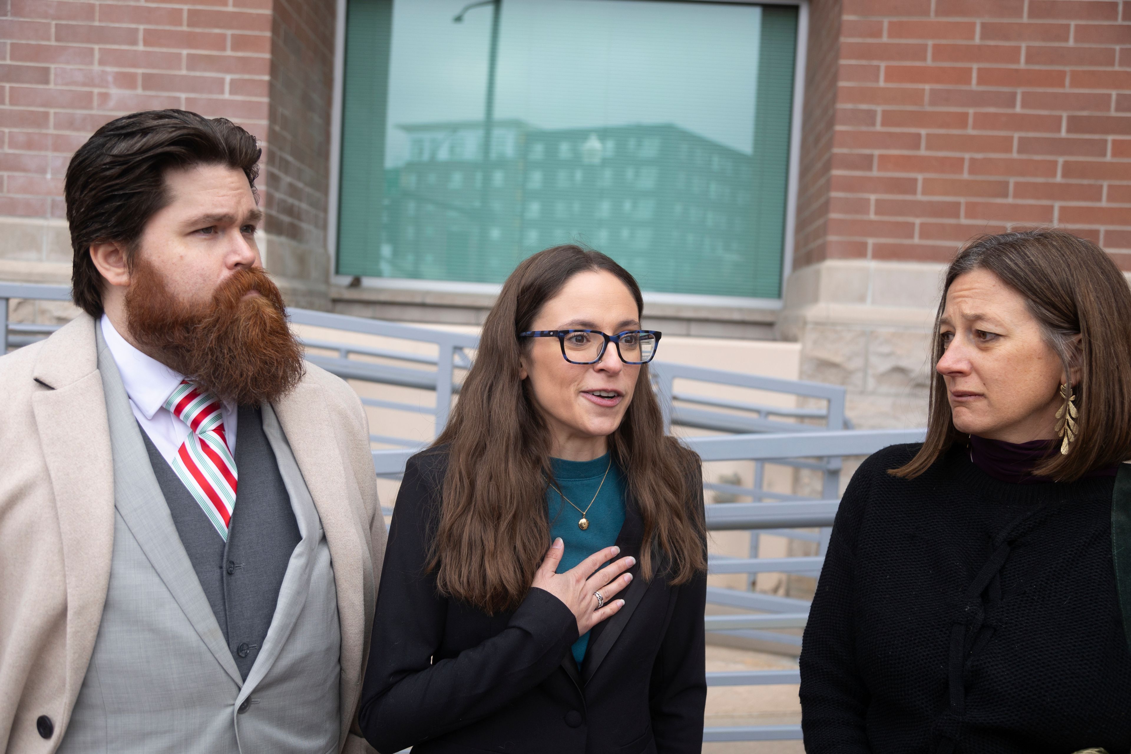 FILE - John Adkins, left to right, and his wife Jennifer, along with family physician Julie Lyons, talk to the media outside the Ada County Courthouse, Dec. 14, 2023, in Boise, Idaho. (AP Photo/Kyle Green, File)