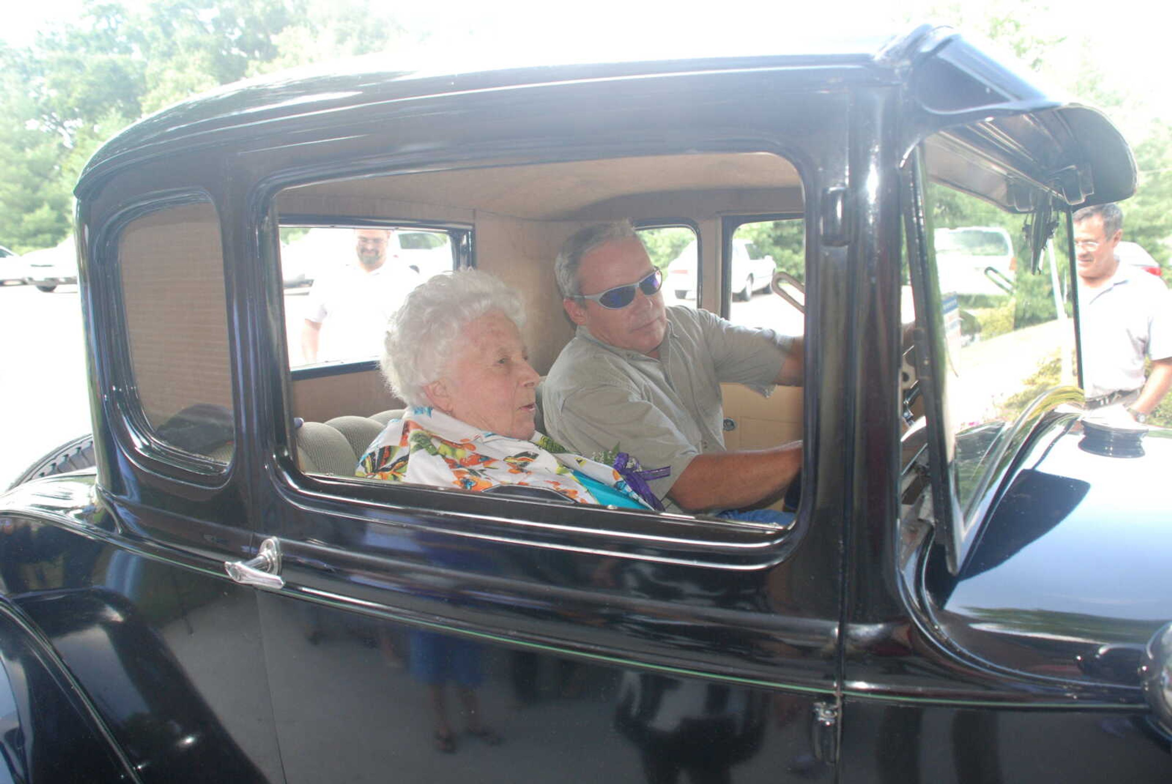 Gwen Schild takes a 90th birthday ride in Fred Vincel's 1931 Ford Model A.