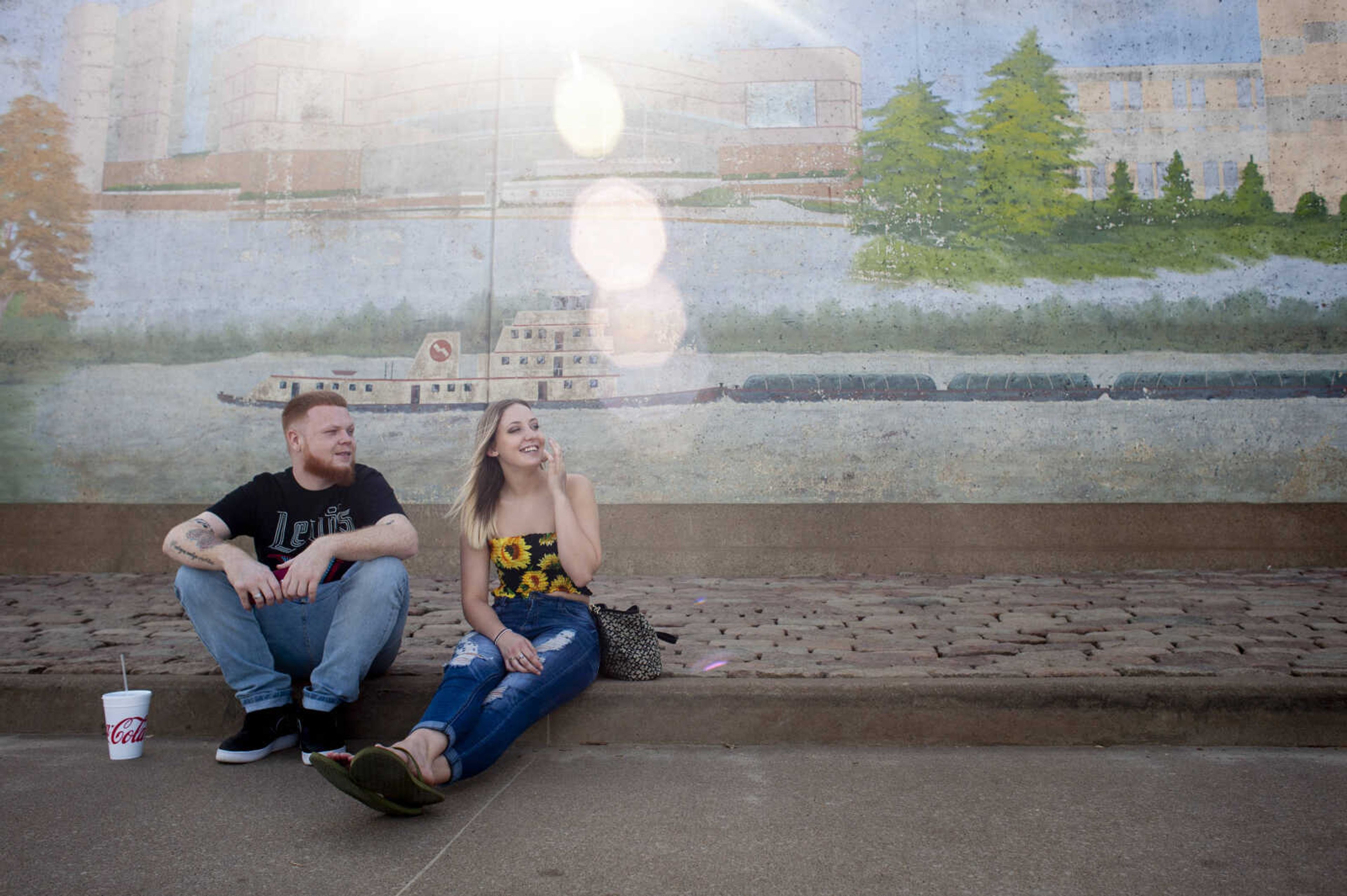 Tyler Bailey and Bekah Baker, who have been dating nearly four years and are both of Cape Girardeau, sit along the Mississippi River on Tuesday, July 30, 2019, at Riverfront Park in Cape Girardeau. The Broadway floodgate was reopened July 22 after being closed since mid-March; the Themis Street gate opened Tuesday.&nbsp;