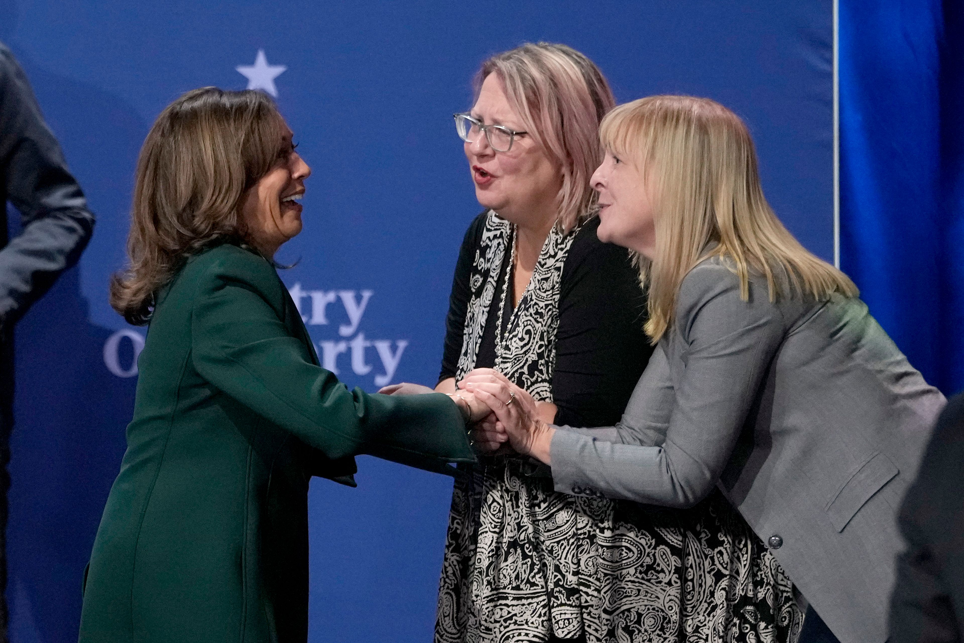 Democratic presidential nominee Vice President Kamala Harris, left, greets members of the audience at the conclusion of a town hall at the Royal Oak Theatre in Royal Oak, Mich., Monday, Oct. 21, 2024. (AP Photo/Carlos Osorio)