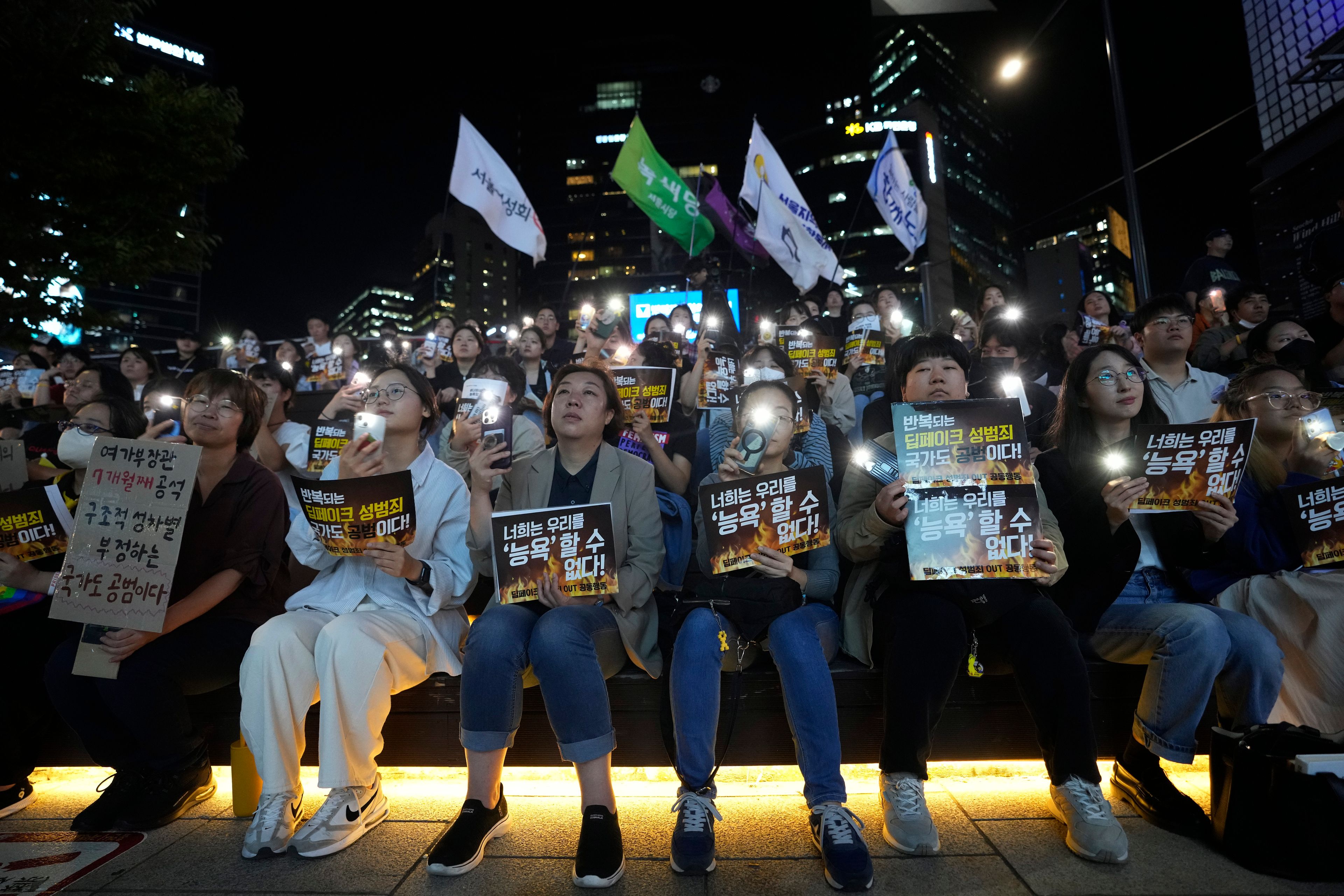 Citizens stage a rally against deepfake sex crime in Seoul, South Korea, Friday, Sept. 27, 2024. The banners read "You can't insult us." (AP Photo/Ahn Young-joon)