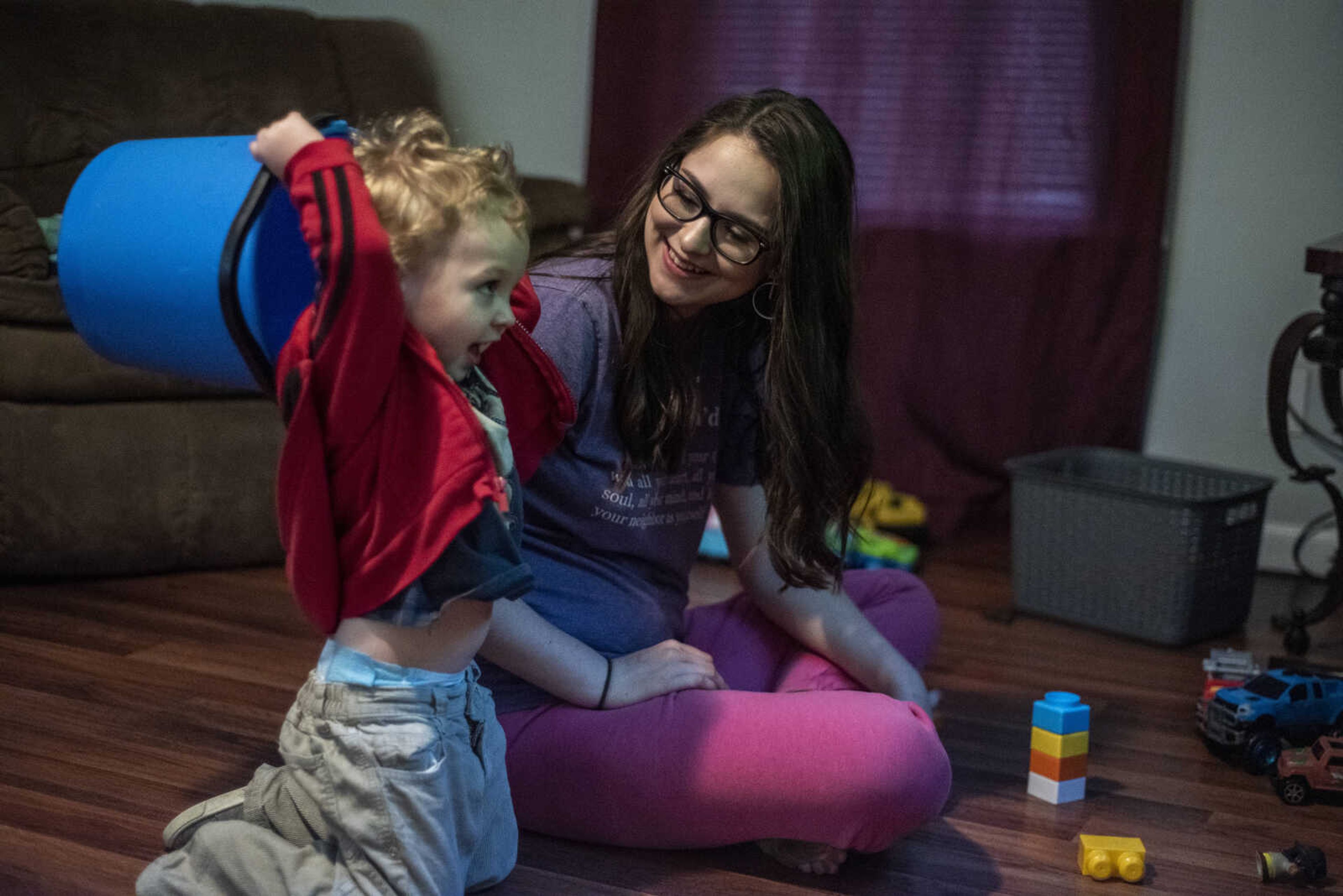 Emily Medlock takes a break from getting ready for graduation to spend time with her son, Phoenix Young, 2, at home Sunday, May 12, 2019, in Cape Girardeau.