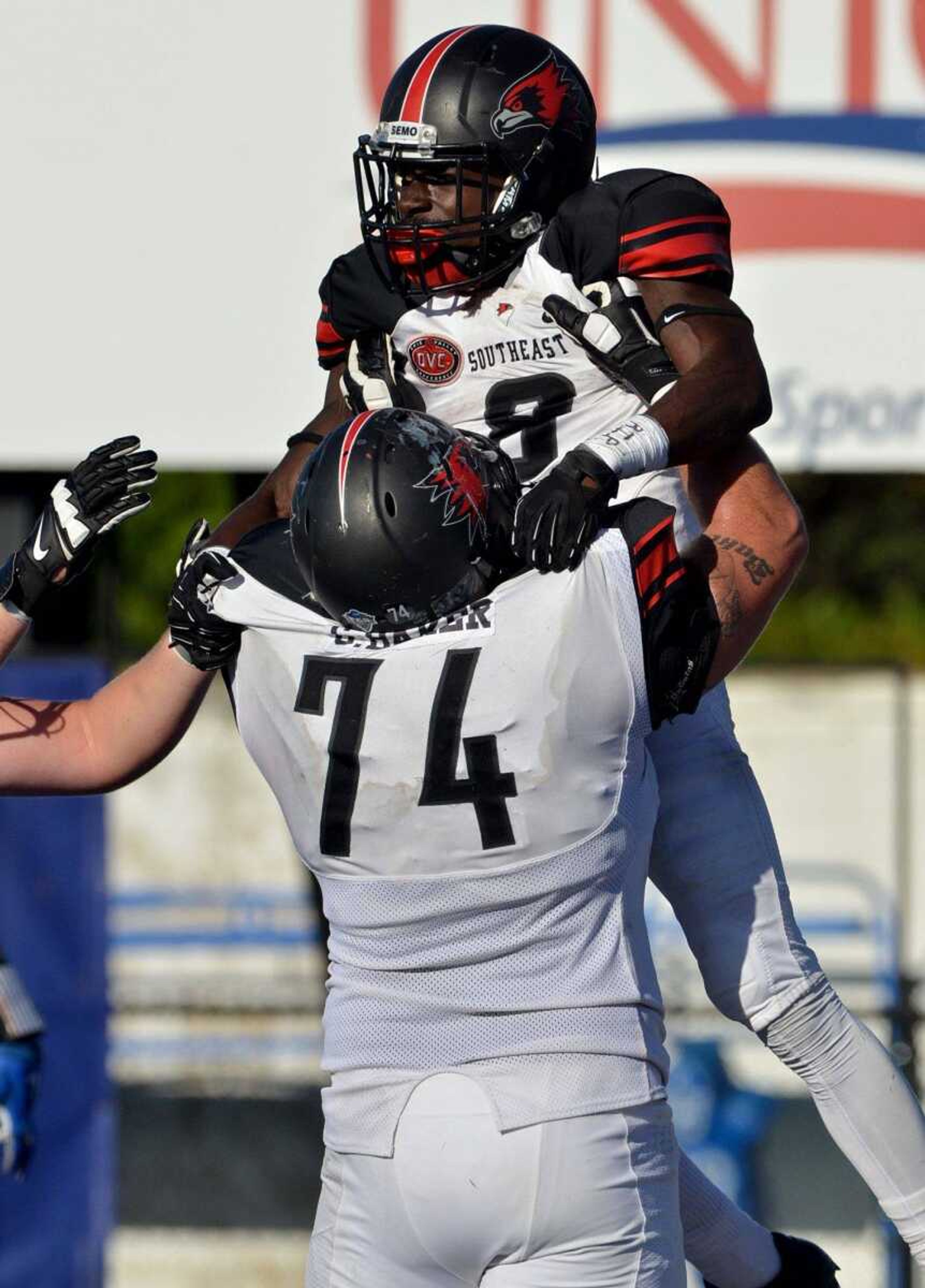 Southeast Missouri State's Garret Baker (74) celebrates with Tremane McCullough after McCullough scored on an 18-yard run in the fourth quarter of Saturday's game against Indiana State in Terre Haute, Indiana. (Joseph C. Garza ~ Terre Haute Tribune Star)