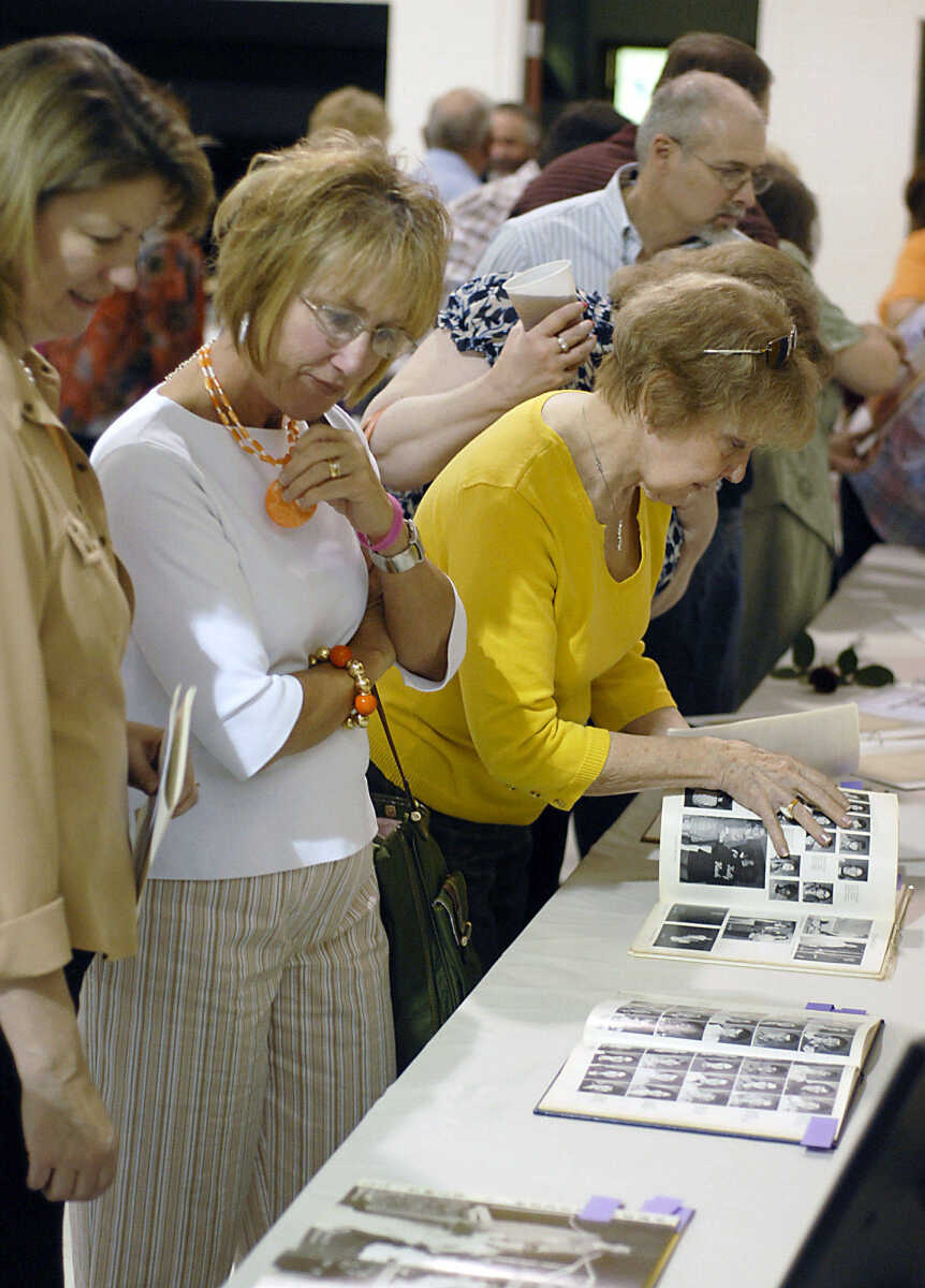 KIT DOYLE ~ kdoyle@semissourian.com
Guests look at photos and yearbooks of Cheryl Scherer following a prayer service Friday at St. Denis in Benton.