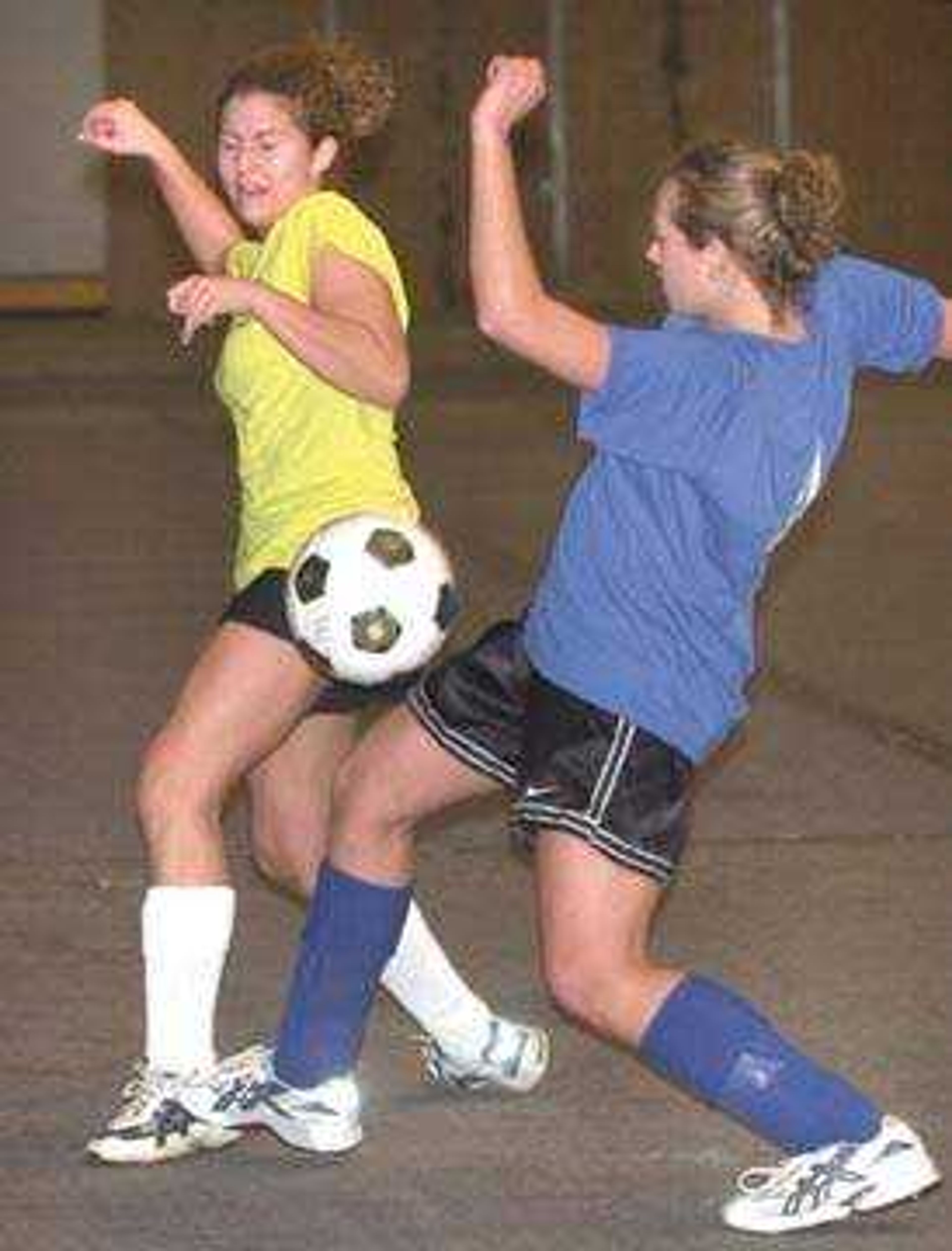 Megan Freeze, left, with Cape Classic Girls challenged Kelsey Scheeter with Blue Twist in the St. Francis Indoor Invitational soccer tournament at the Show Me Center. Cape Classic won the 18-under girls contest 5-0.