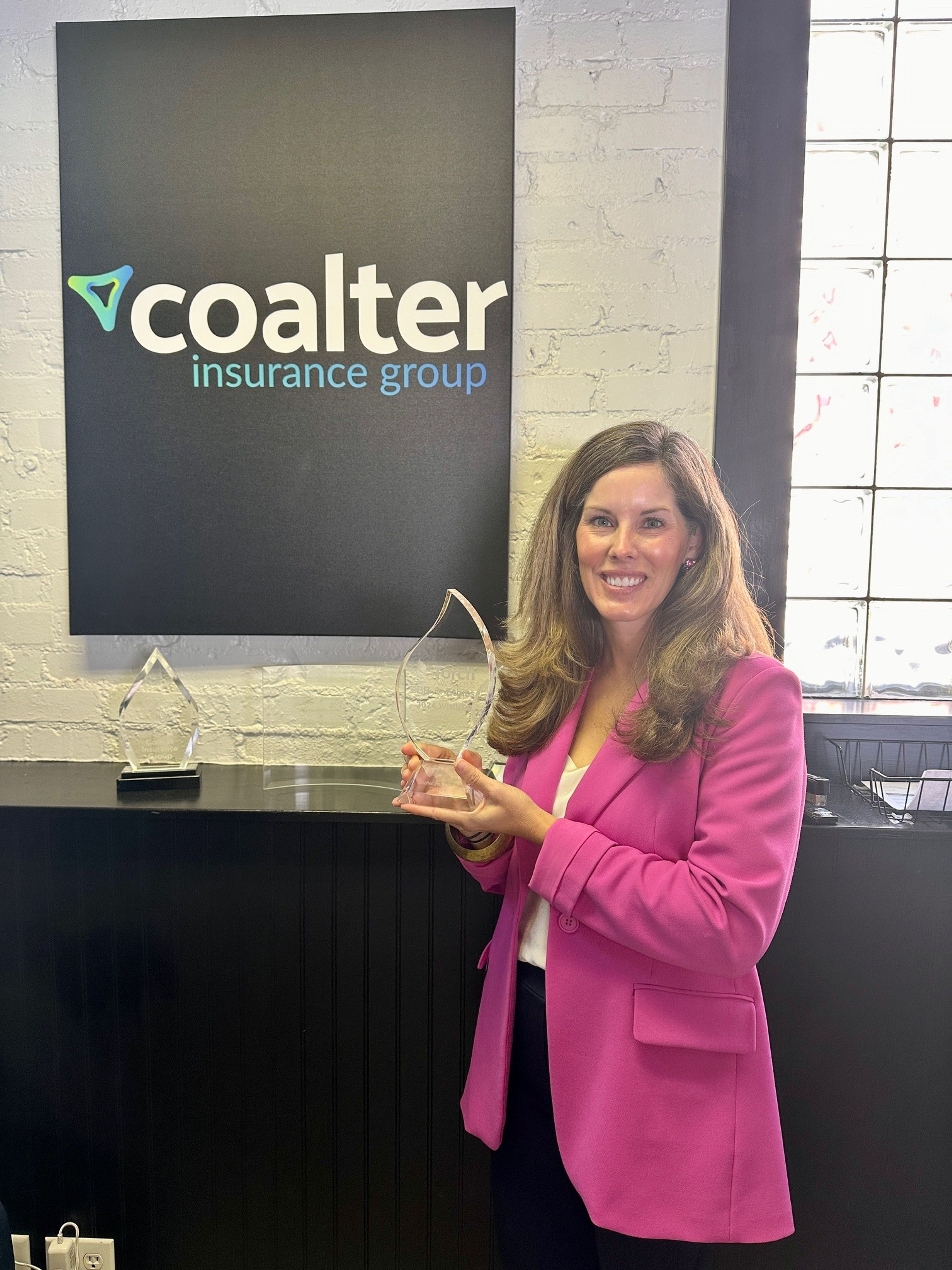 Laura Coalter Parker of Coalter Insurance Group with the Torch Award her company won. Hers was one of three businesses awarded one by the Cape Girardeau office of the Better Business Bureau.