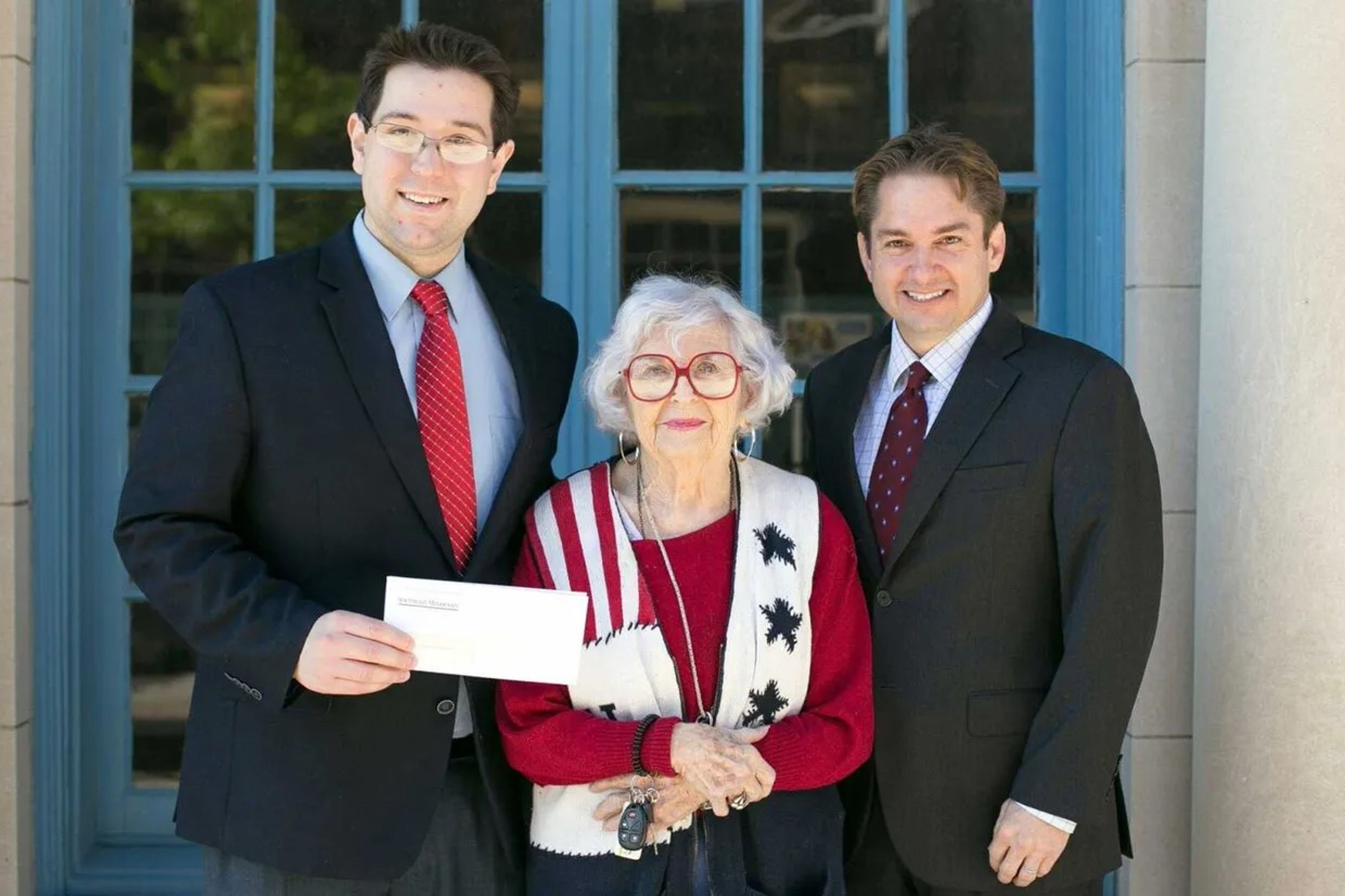 Southeast Missourian assistant publisher and general manager Lucas Presson, left, and publisher Jon K. Rust, right, honor Mary Kasten with the newspaper's Spirit of America award in 2014. Kasten, who died Saturday, Oct. 12, received numerous awards and accolades during her lifetime for her service to the community.