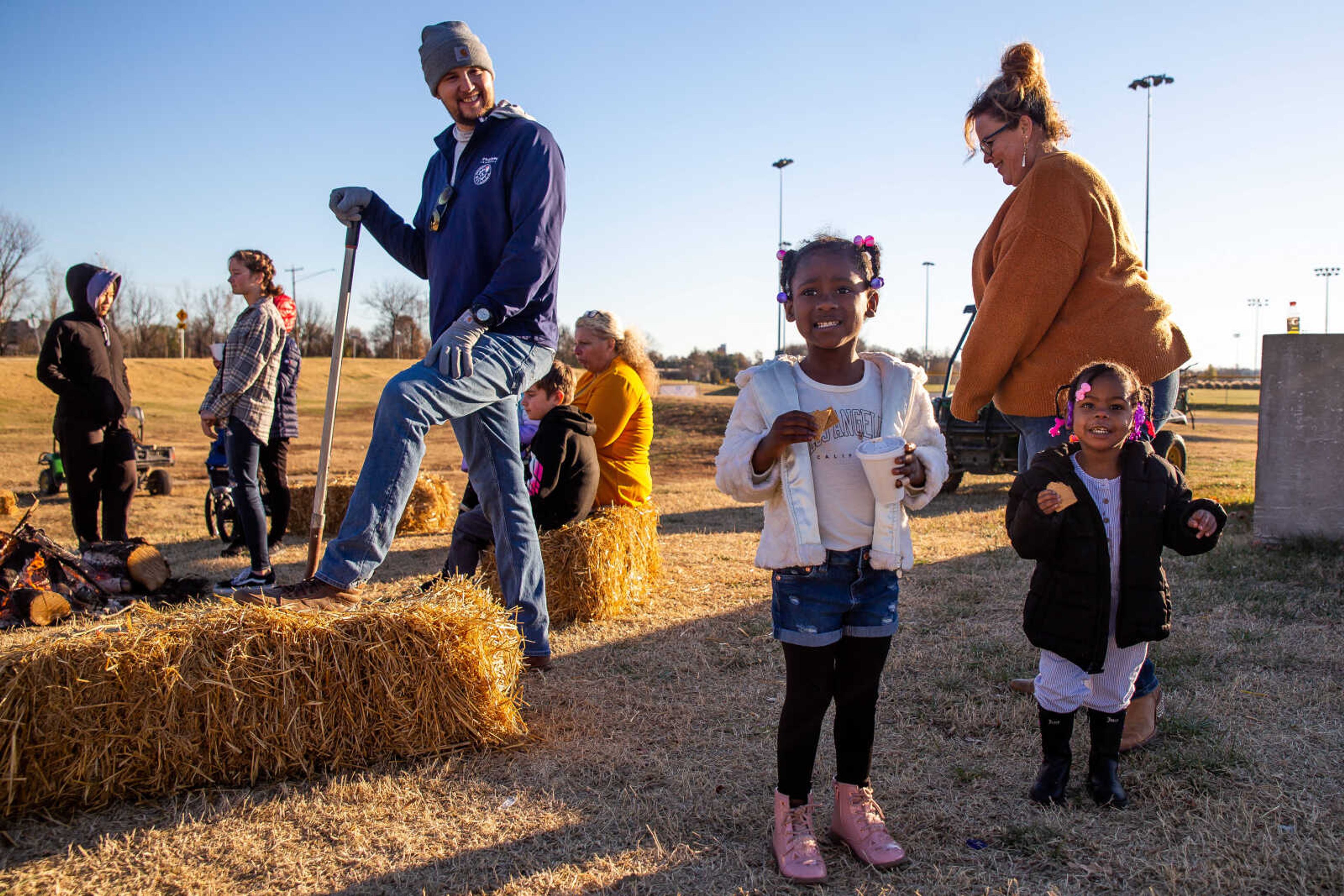 Honesty Williams, center, and A'Iyanna Williams, 4 and 2, eat s'mores by a campfire at the Fall Family Festival on Sunday, Nov. 20 at the Shawnee Park Center in Cape Girardeau.