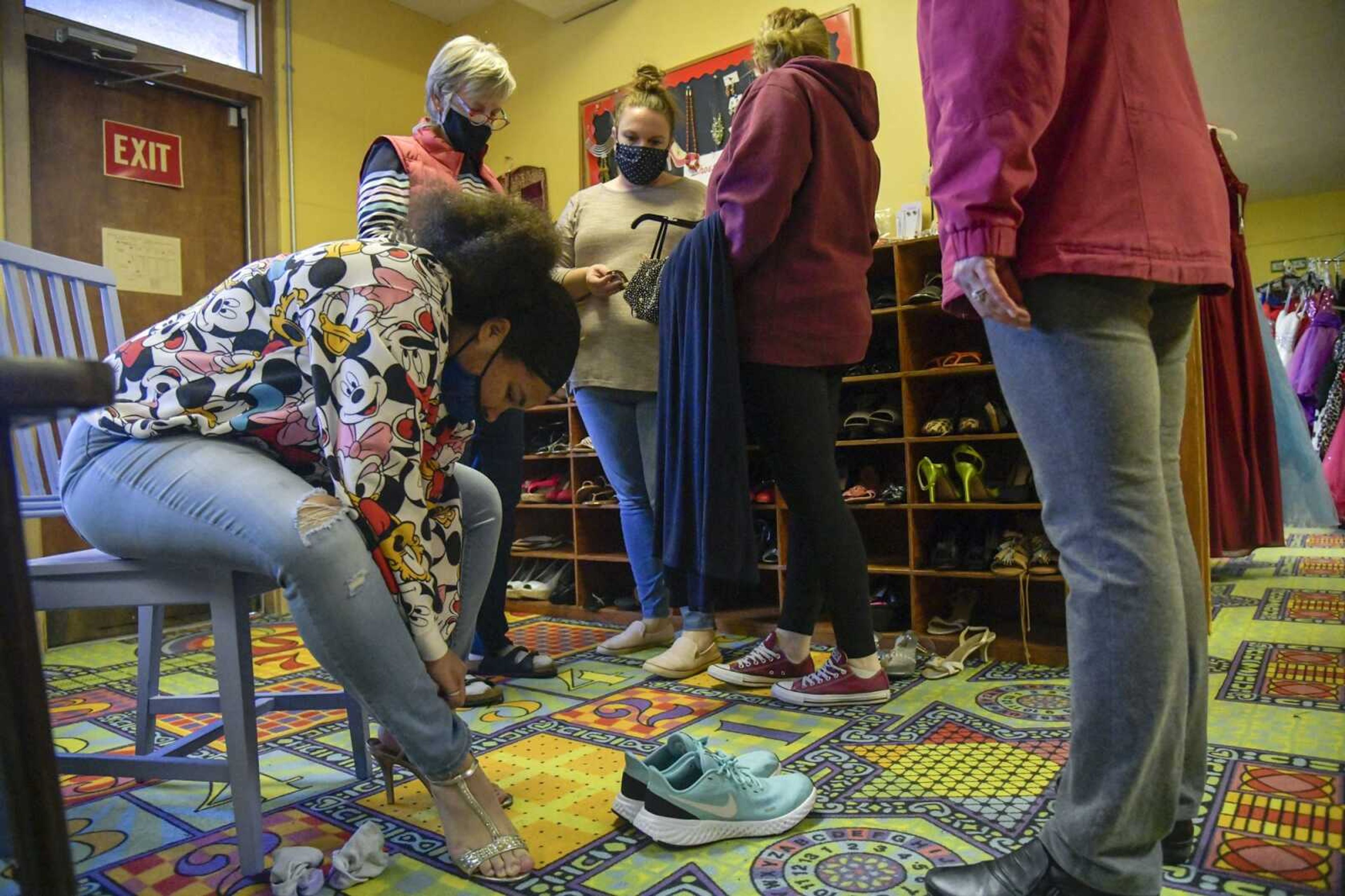 Ivionna Howard, left, tries on high heels during her shopping experience with the SEMO Prom Mothers at the Westminster Presbyterian Church in Cape Girardeau on Monday, March 15, 2021.