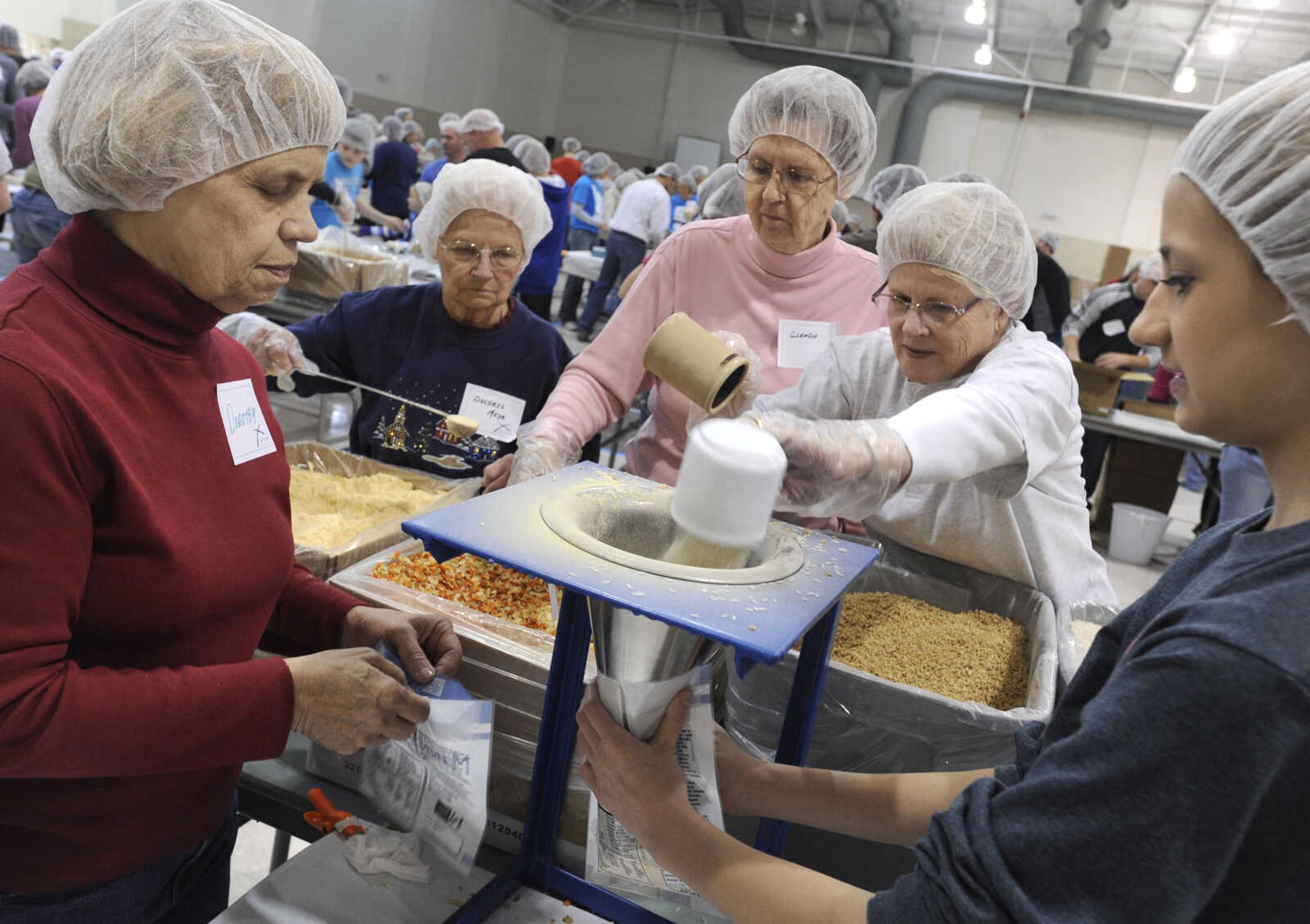 Dorothy Evans, left, Dolores Meyr, Glenda Wunderlich, Sandy Nagel and Mandy Evans operate a MannaPack Rice line at the Osage Centre.