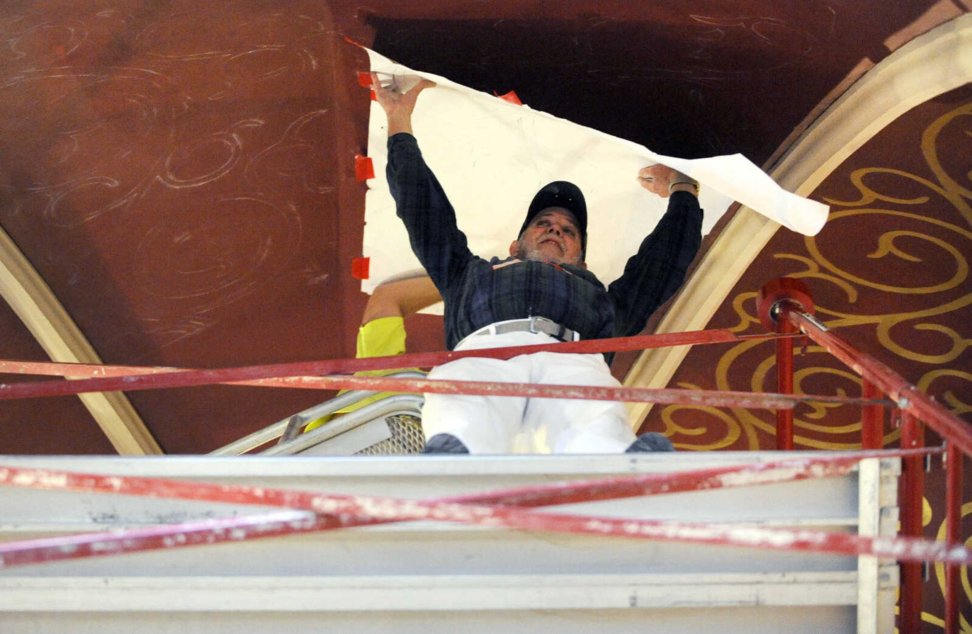 LAURA SIMON ~ lsimon@semissourian.com

Gary West stretches out the stencil he made as Roy Diamond taps it with chalk to create the outline on the ceiling above the altar at St. John's Catholic Church in Leopold, Missouri on March 3, 2016.