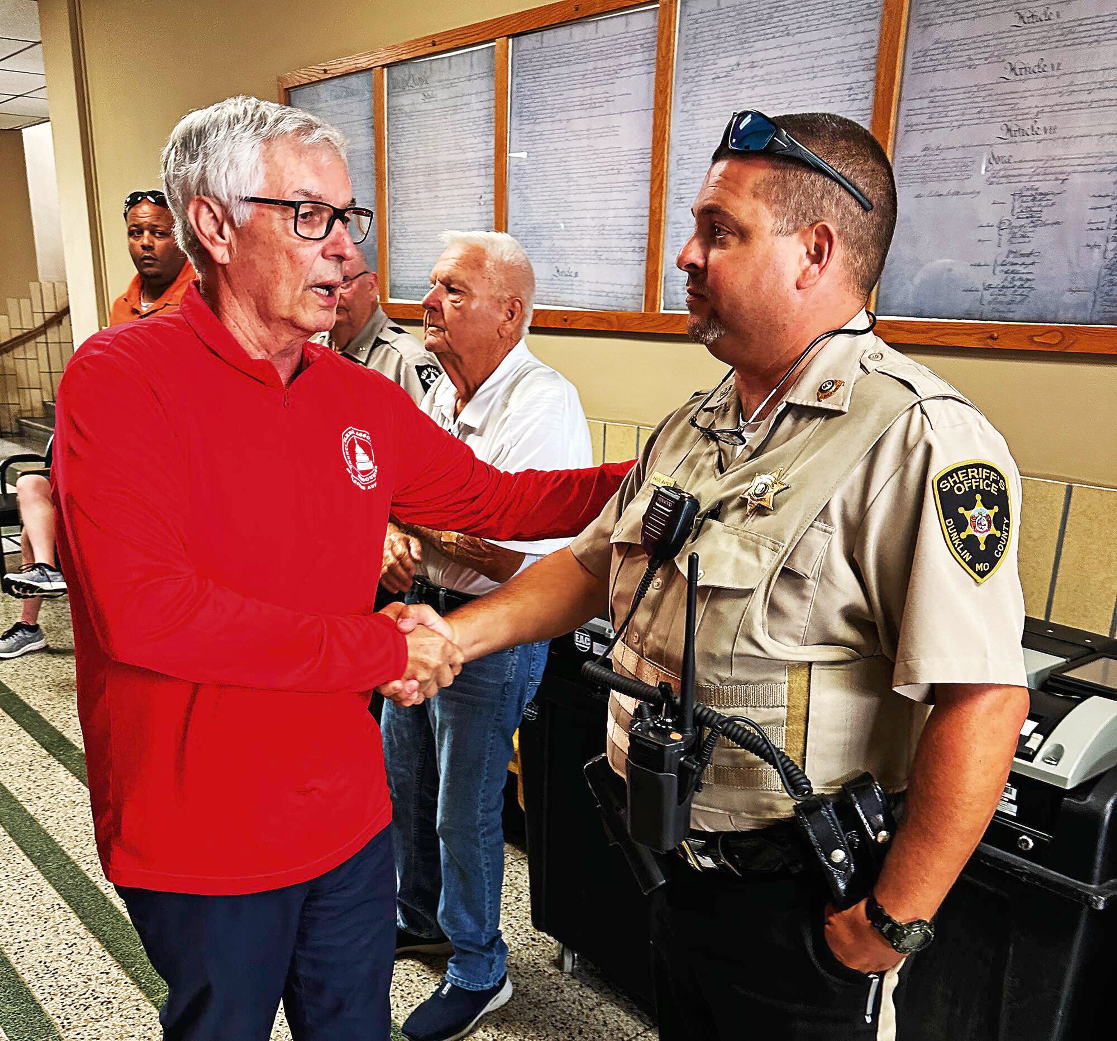 Dunklin County Clerk Kent Hampton, left, greets Dunklin County sheriff’s deputy and candidate for sheriff Aaron Waynick on Aug. 12 at the Dunklin County Courthouse in Kennett.