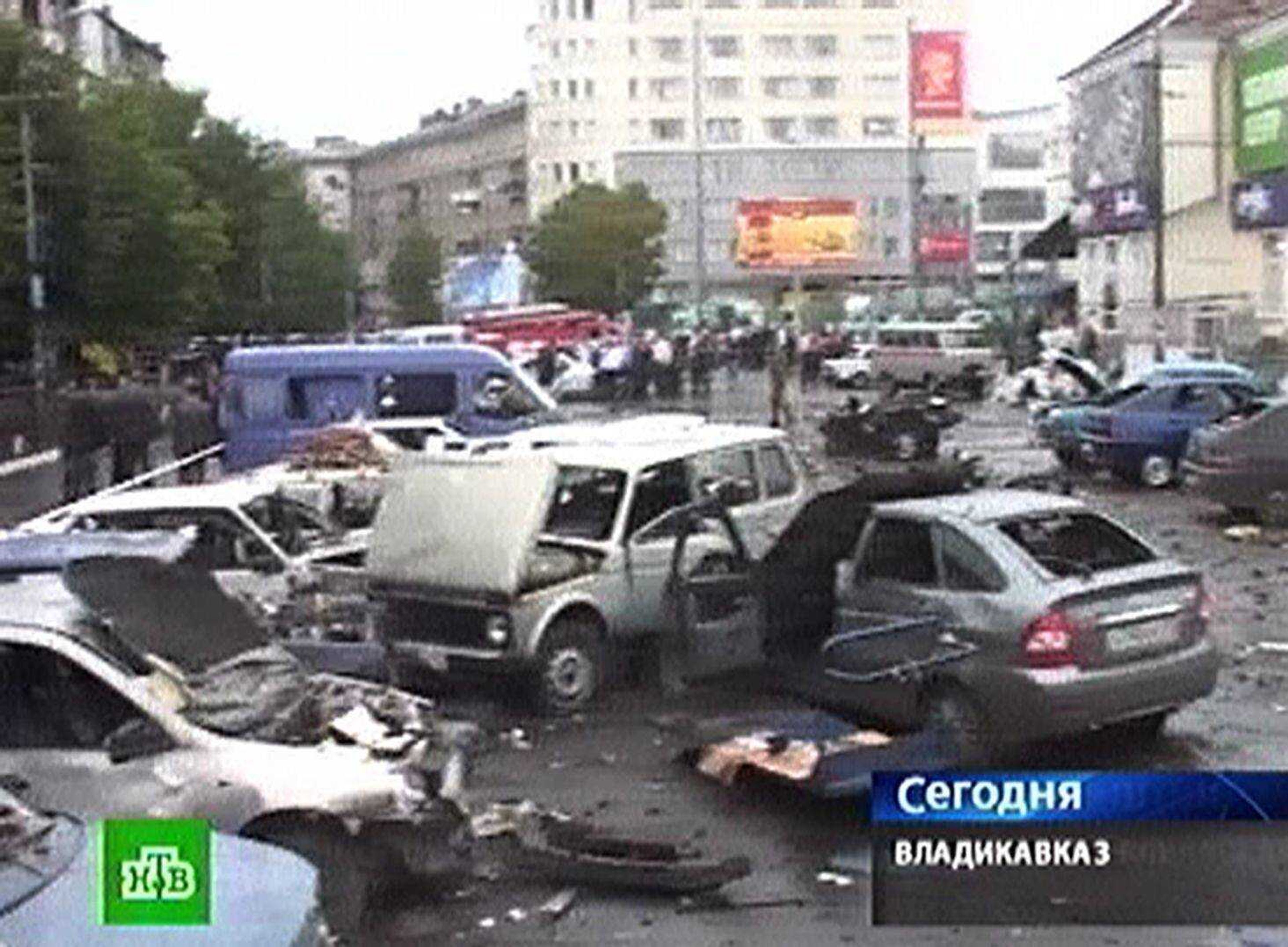 In this image made from television, cars damaged in a suicide car attack are seen Thursday in a square outside a market in Vladikavkaz, North Caucasus, Russia. More than a dozen were killed and more than 130 people wounded in one of the worst terror attacks in the volatile region in years, officials said. (NTV Russian Channel)