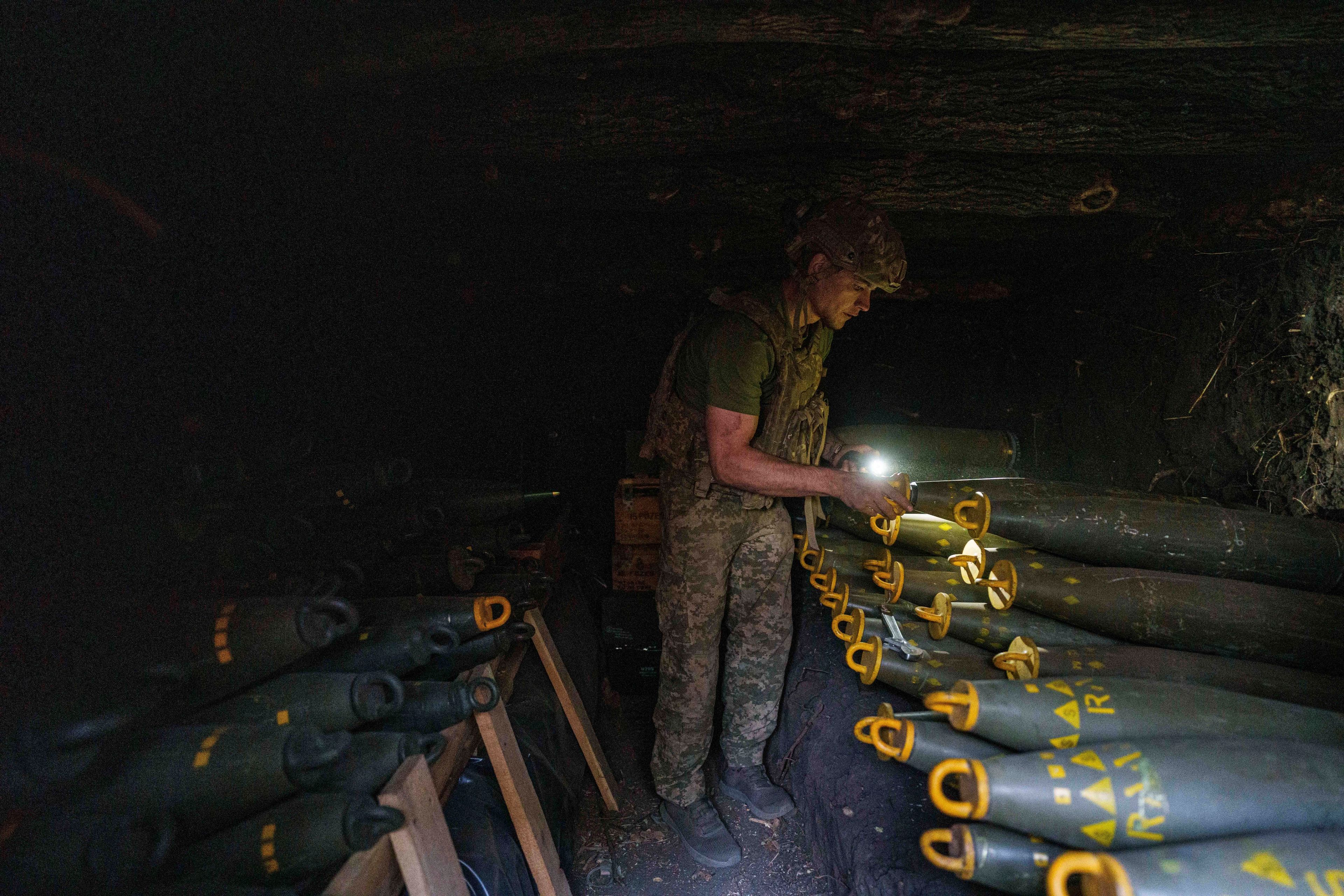 FILE – A serviceman identified only as Oleh of the 148th artillery brigade of Ukraine’s air assault forces prepares 155mm artillery shells before firing them toward Russian positions at the front line in Donetsk region of Ukraine, on Aug. 21, 2024. (AP Photo/Evgeniy Maloletka, File)