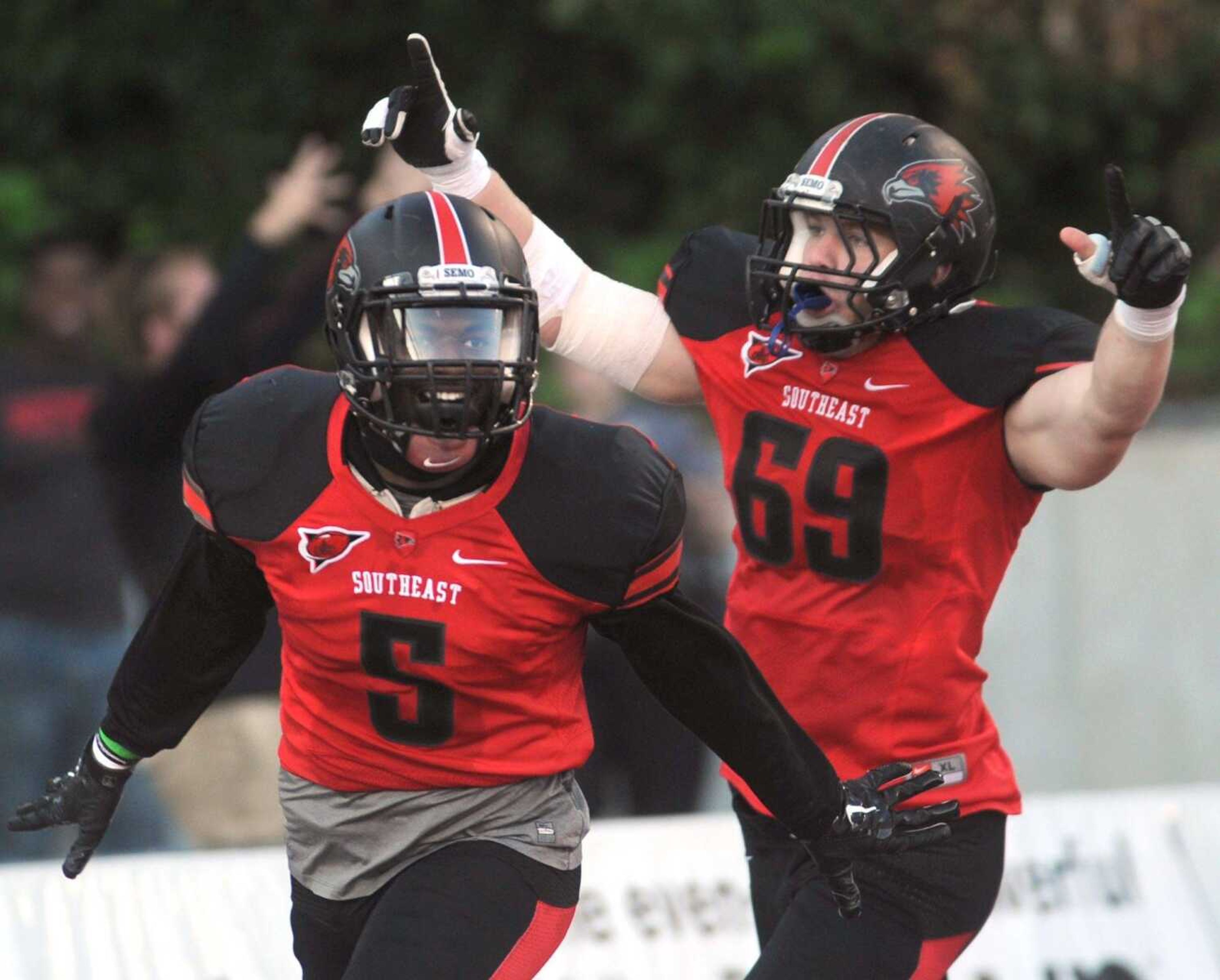 Southeast Missouri State's Eriq Moore, left, and John Popovich celebrate after Moore's 42-yard touchdown run after he recovered a fumble by Southern Illinois' Connor Iwema during the first quarter Saturday, Sept. 12, 2015 at Houck Stadium. (Fred Lynch)