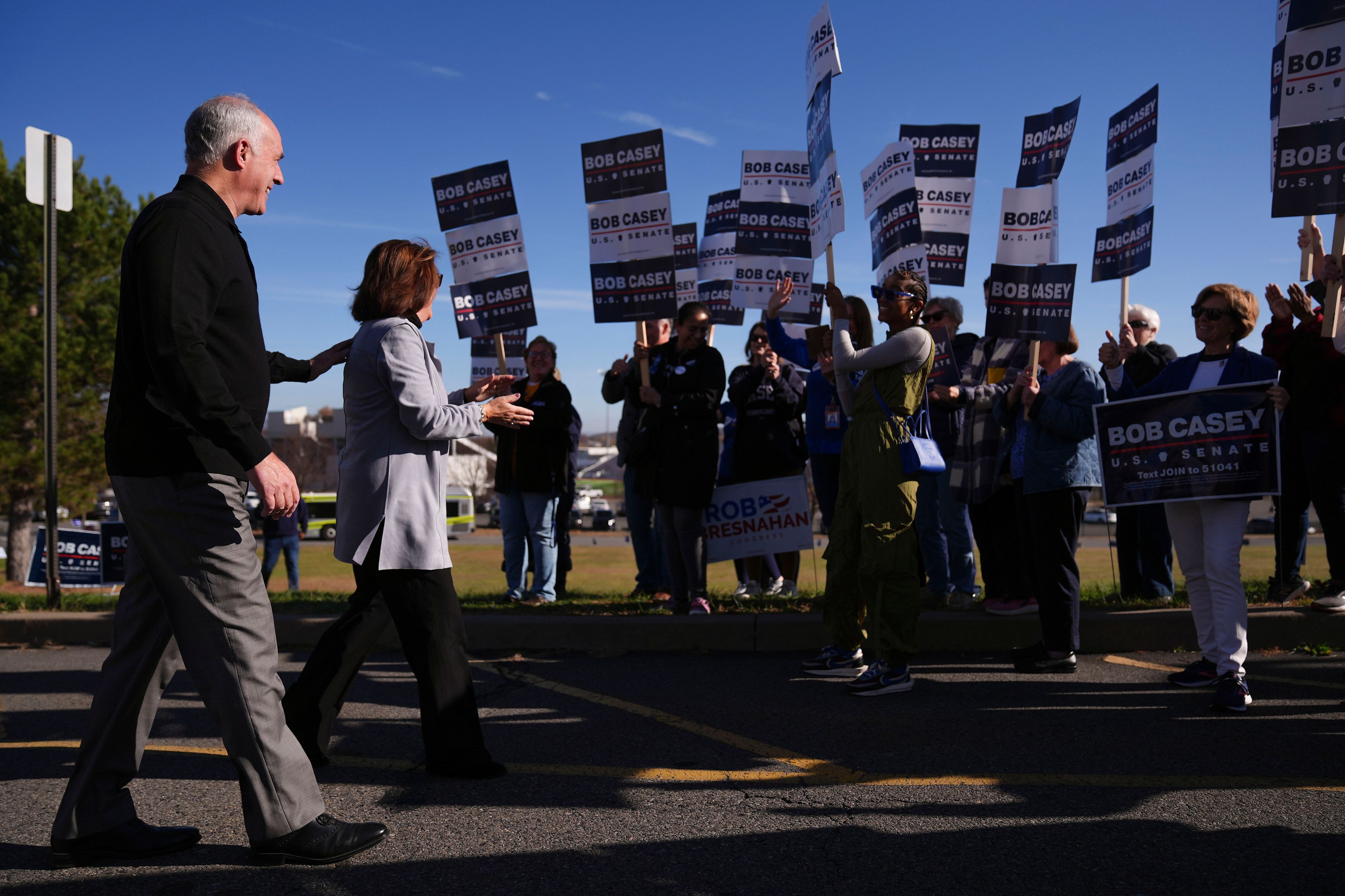 Sen. Bob Casey, D-Pa., left,, arrives to vote, Tuesday, Nov. 5, 2024, in Scranton, Pa. (AP Photo/Matt Rourke)