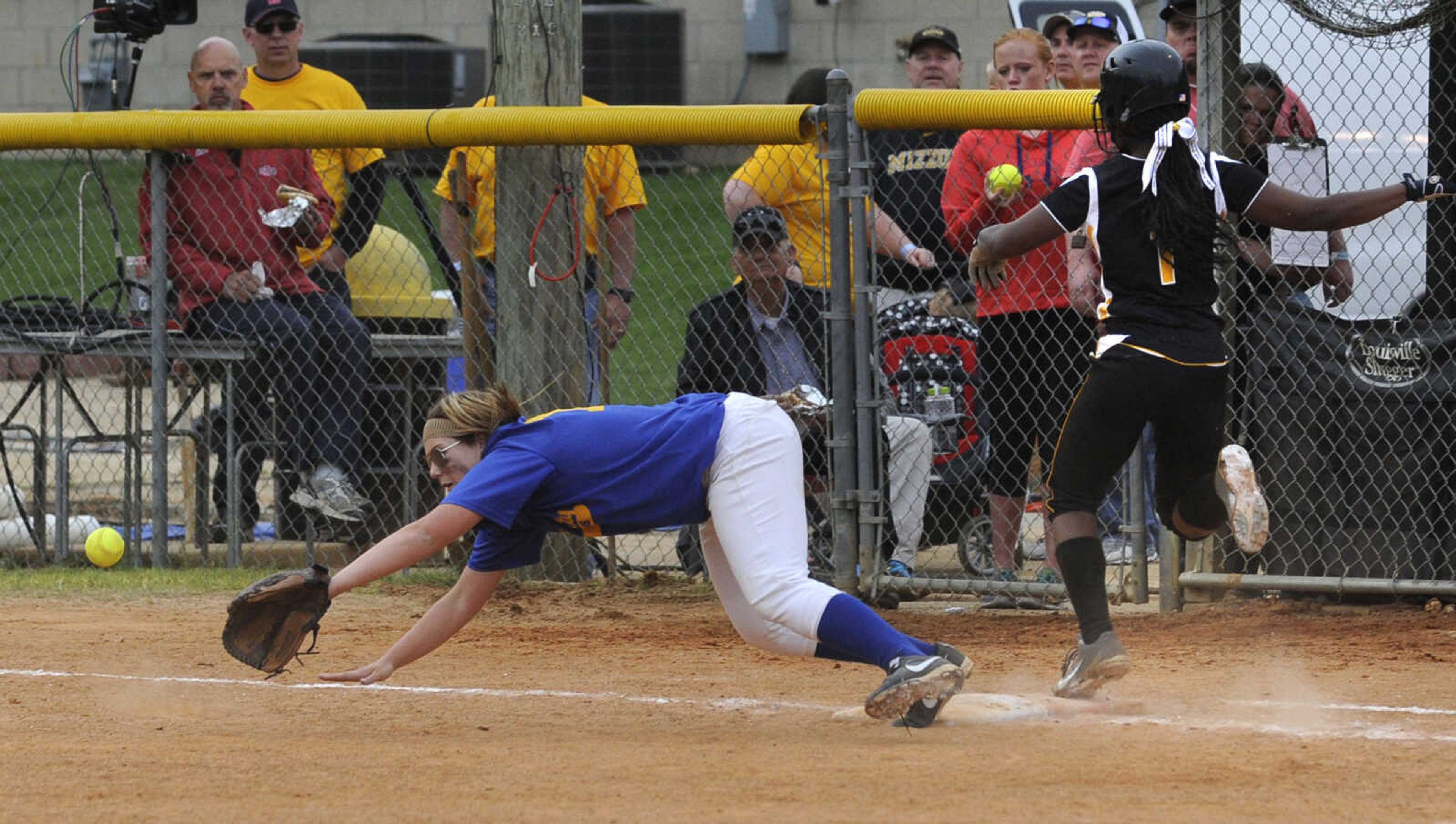 Kennett's Anna Wheeler reaches first base as the throw gets past Scott City first baseman Elizabeth Hensley, during the seventh inning in the Class 1 state semifinal game Friday, May 16, 2014 in Poplar Bluff, Mo. Wheeler reached third base on the throwing error. (Fred Lynch)