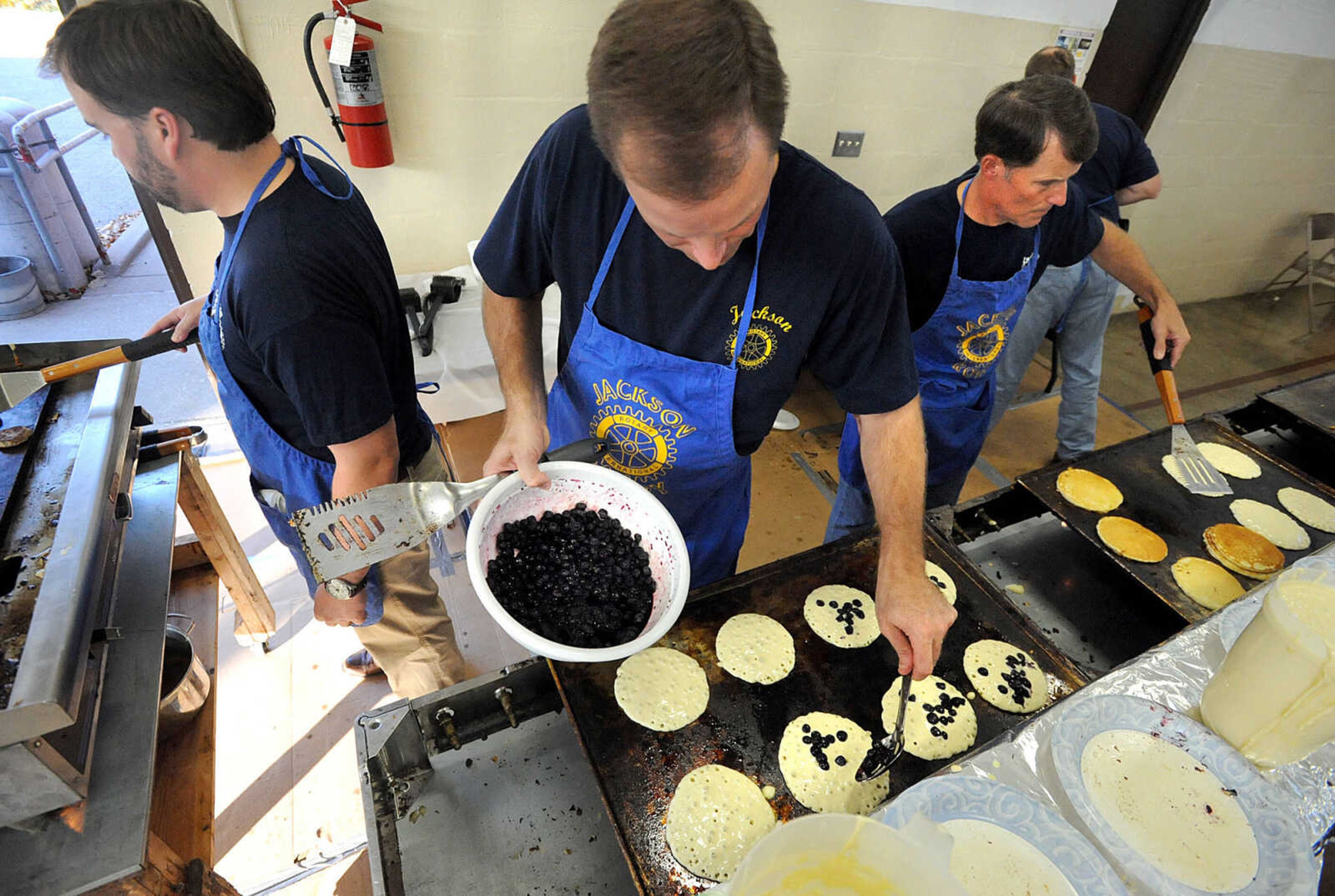 LAURA SIMON ~ lsimon@semissourian.com
Rotarians Brandon Pylate, left, Tim Walker and Doug Mueller man the griddles Tuesday, Oct. 23, 2012 during the Jackson Rotary Pancake Day at the National Guard Armory.