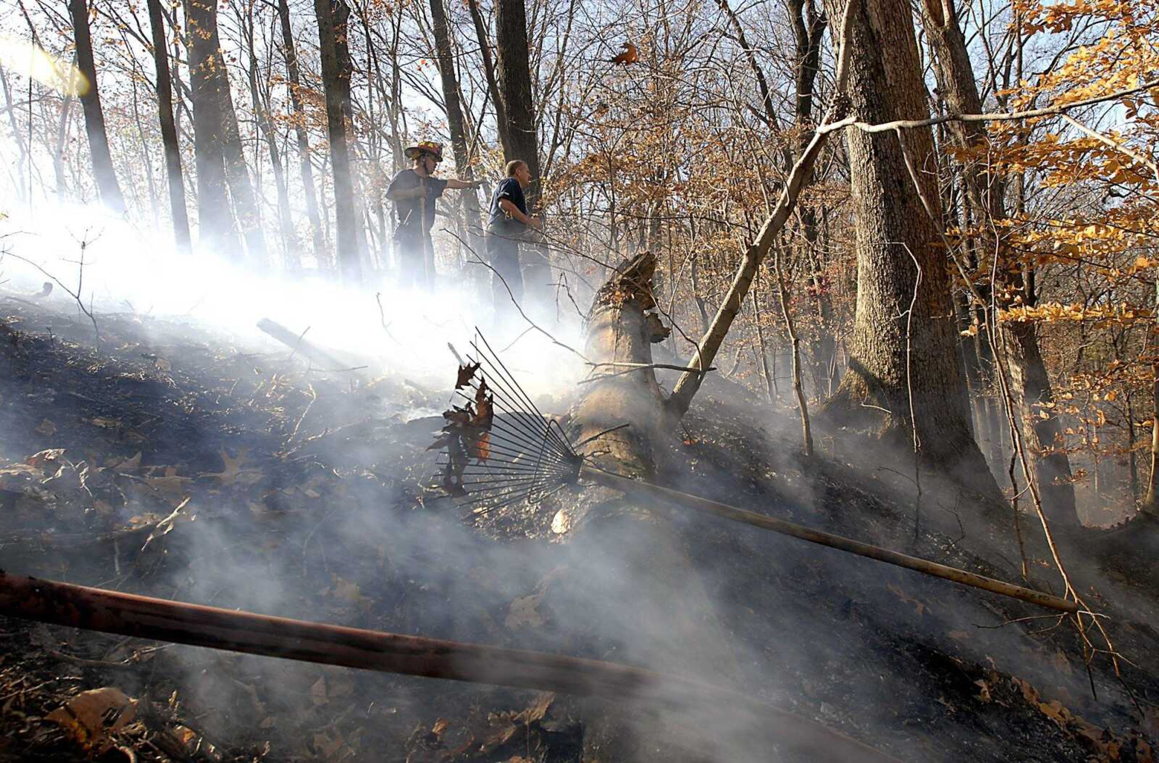 KIT DOYLE ~ kdoyle@semissourian.com
Captain Kelly Allen points out fire line areas to Assistant Chief Mark Hasheider Wednesday,  November 11, 2009, in the Juden Creek Conservation Area.  Assistant Chief Mark Hasheider called the five-acre burn suspicious with a similar burn occurring Tuesday evening in the same area.  The brush fire was in a remote location in difficult terrain for personnel and equipment to reach.