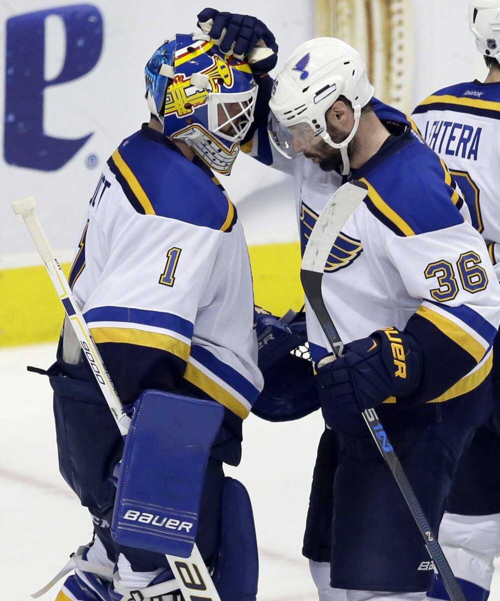 St. Louis Blues goalie Brian Elliott (1) and Troy Brouwer (36) congratulate each other after Game 5 of the NHL hockey Stanley Cup Western Conference semifinals against the Dallas Stars Saturday, May 7, 2016, in Dallas. The Blues won 4-1. (AP Photo/LM Otero)