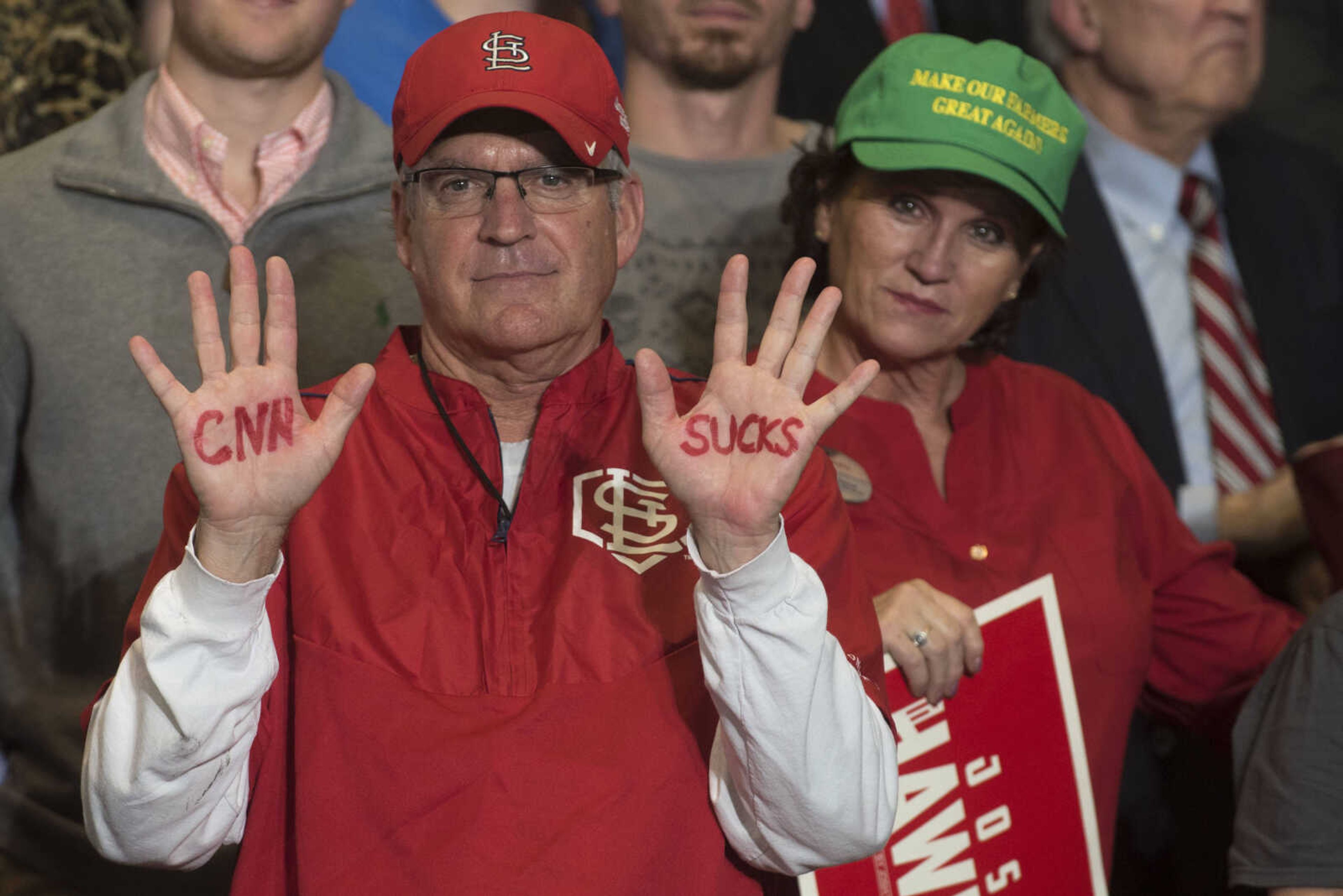 A rally attendee shows a hand-painted message to members of the media during a Make America Great Again rally Monday, Nov. 5, 2018, at the Show Me Center in Cape Girardeau.