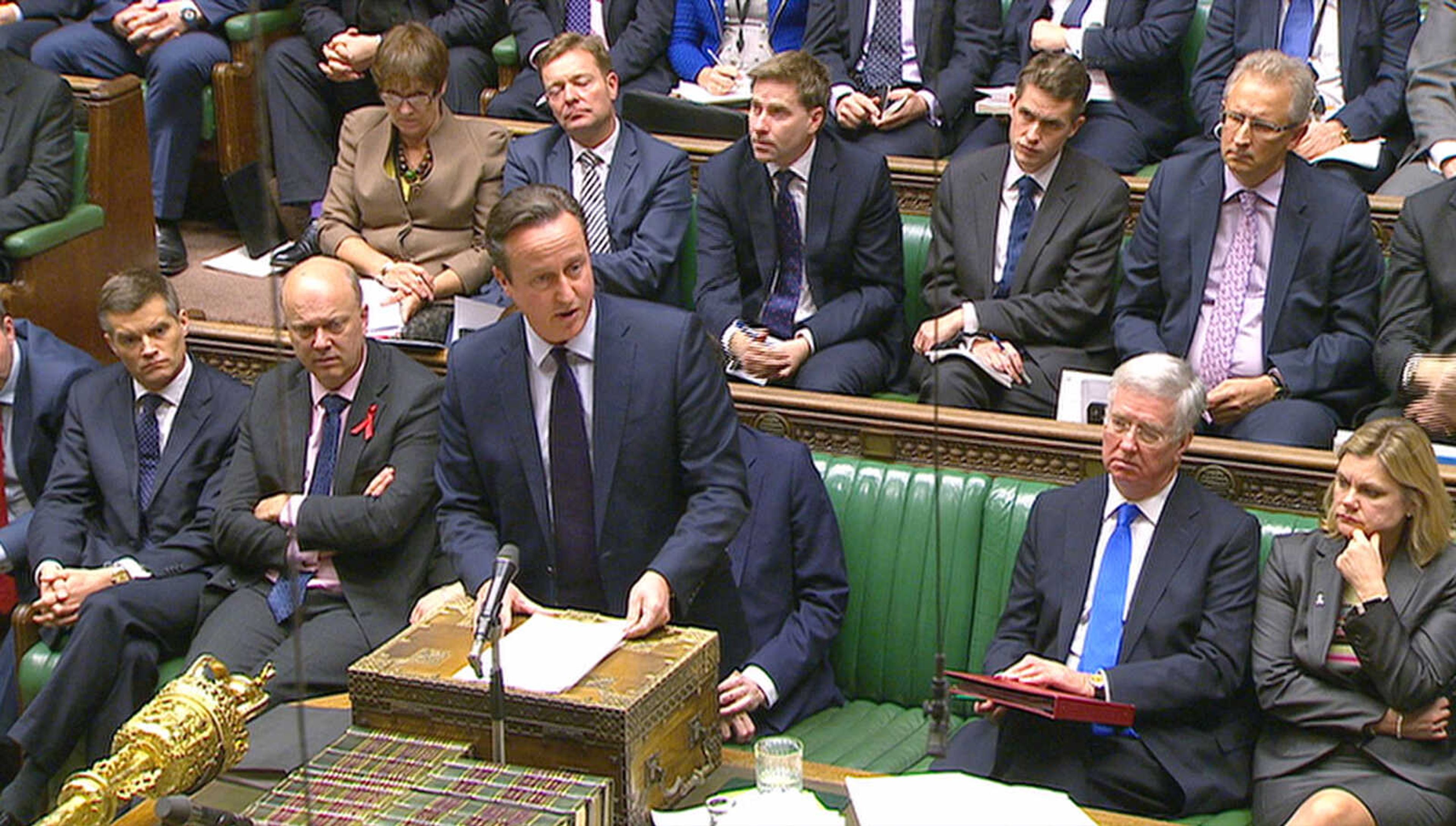 British Prime Minister David Cameron talks to lawmakers inside the House of Commons on Wednesday in London during a debate on launching airstrikes against Islamic State extremists inside Syria. (Parliamentary Recording Unit via AP Video)