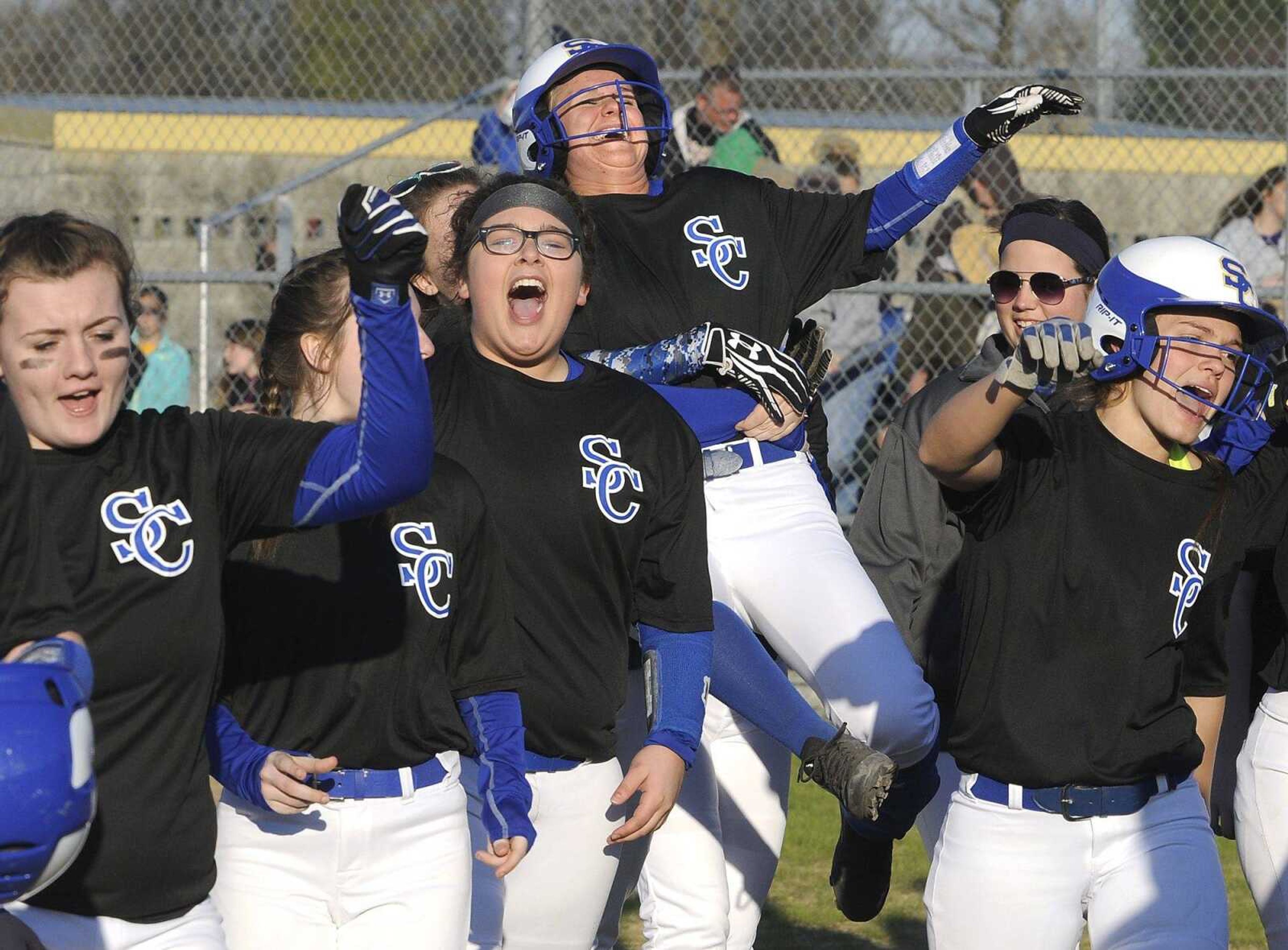 Scott City's Valerie Bahr is hoisted by teammates in celebration of her walk-off home run that defeated Oran 4-2 on Monday in Scott City.