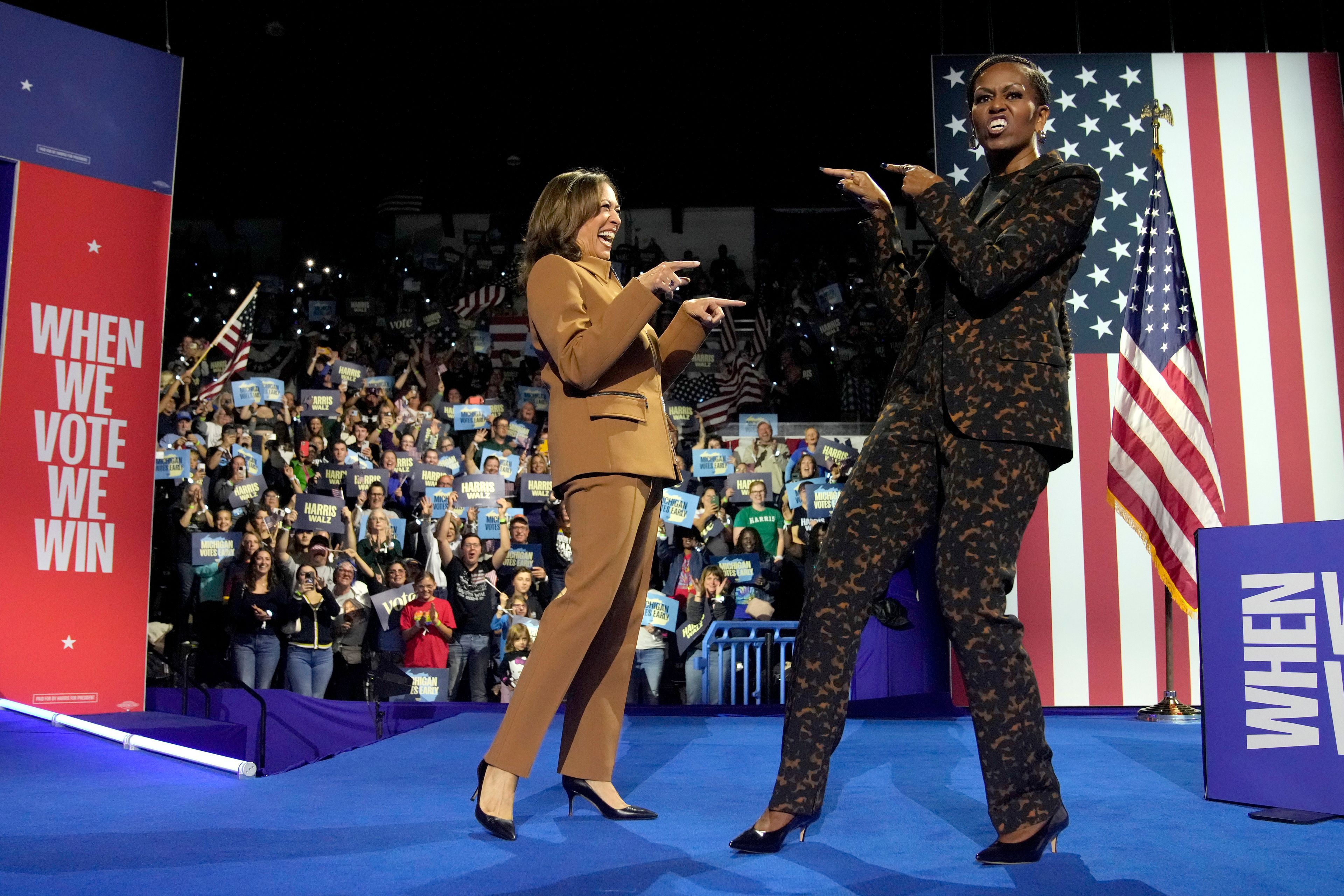 Democratic presidential nominee Vice President Kamala Harris, left, and former first lady Michelle Obama arrive to speak during a campaign rally at the Wings Event Center in Kalamazoo, Mich. (AP Photo/Jacquelyn Martin)