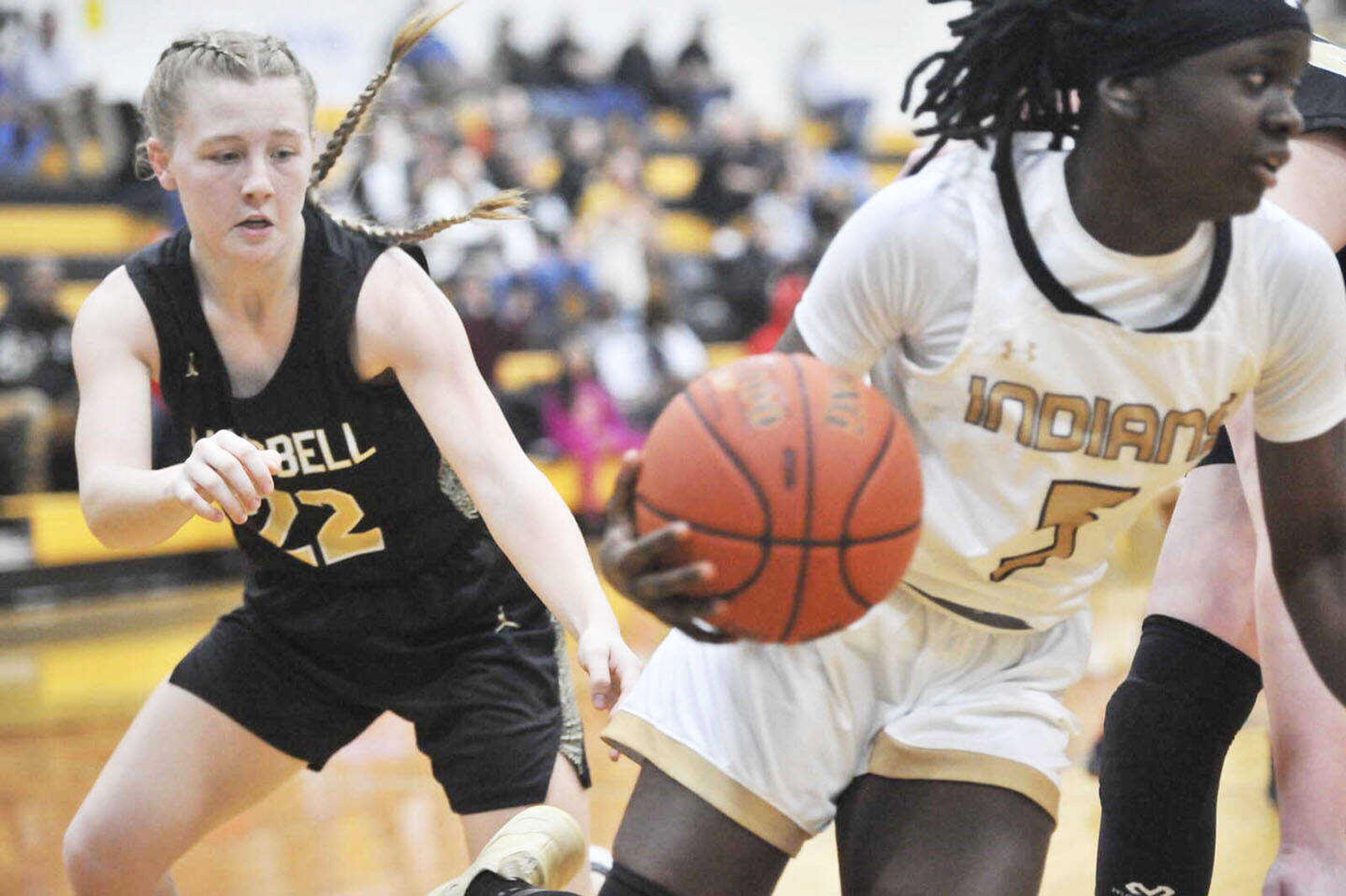 Campbell High School girls basketball player Elyssa Schatz (left) attempts to poke the ball away from a Hayti dribbler during an Al Jackson Classic tournament game from a previous season.