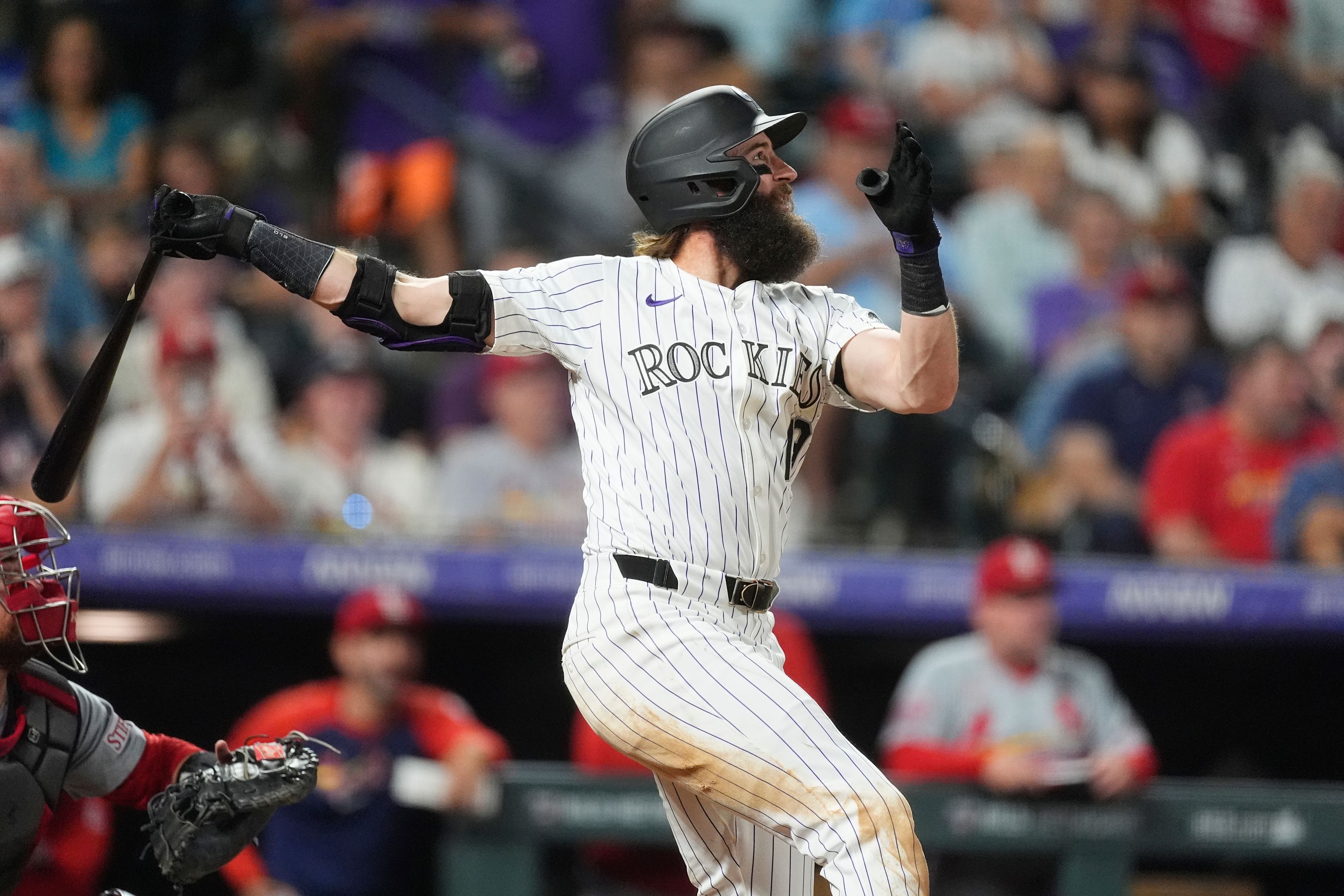 Colorado Rockies' Charlie Blackmon follows the flight of his single off St. Louis Cardinals starting pitcher Erick Fedde in sixth inning of a baseball game Wednesday, Sept. 25, 2024, in Denver. (AP Photo/David Zalubowski)