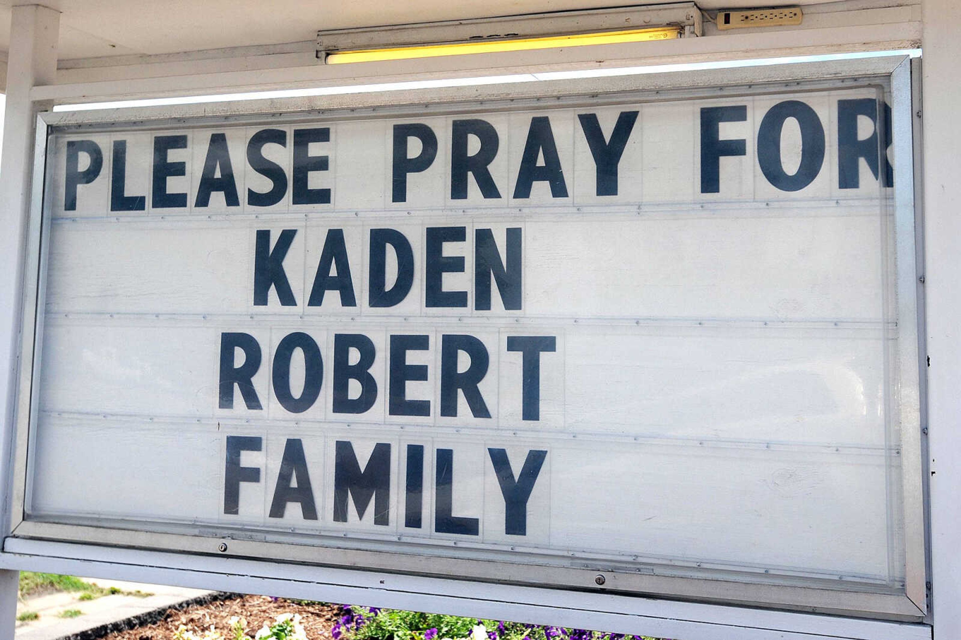 A sign outside Benton City Hall on Tuesday asks people to pray for Kaden Robert and his family. (Laura Simon)