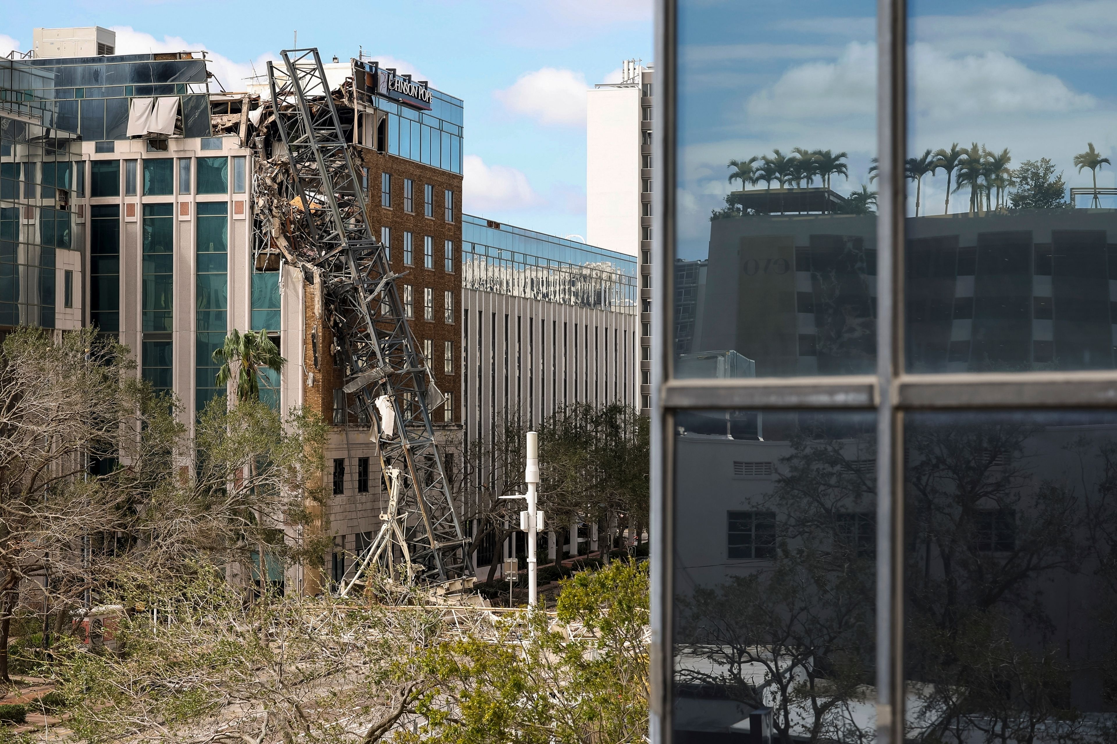 A high rise construction crane broke apart and crashed into the building across the street during Hurricane Milton on Thursday, Oct. 10, 2024, in St. Petersburg, Fla. (AP Photo/Mike Carlson)