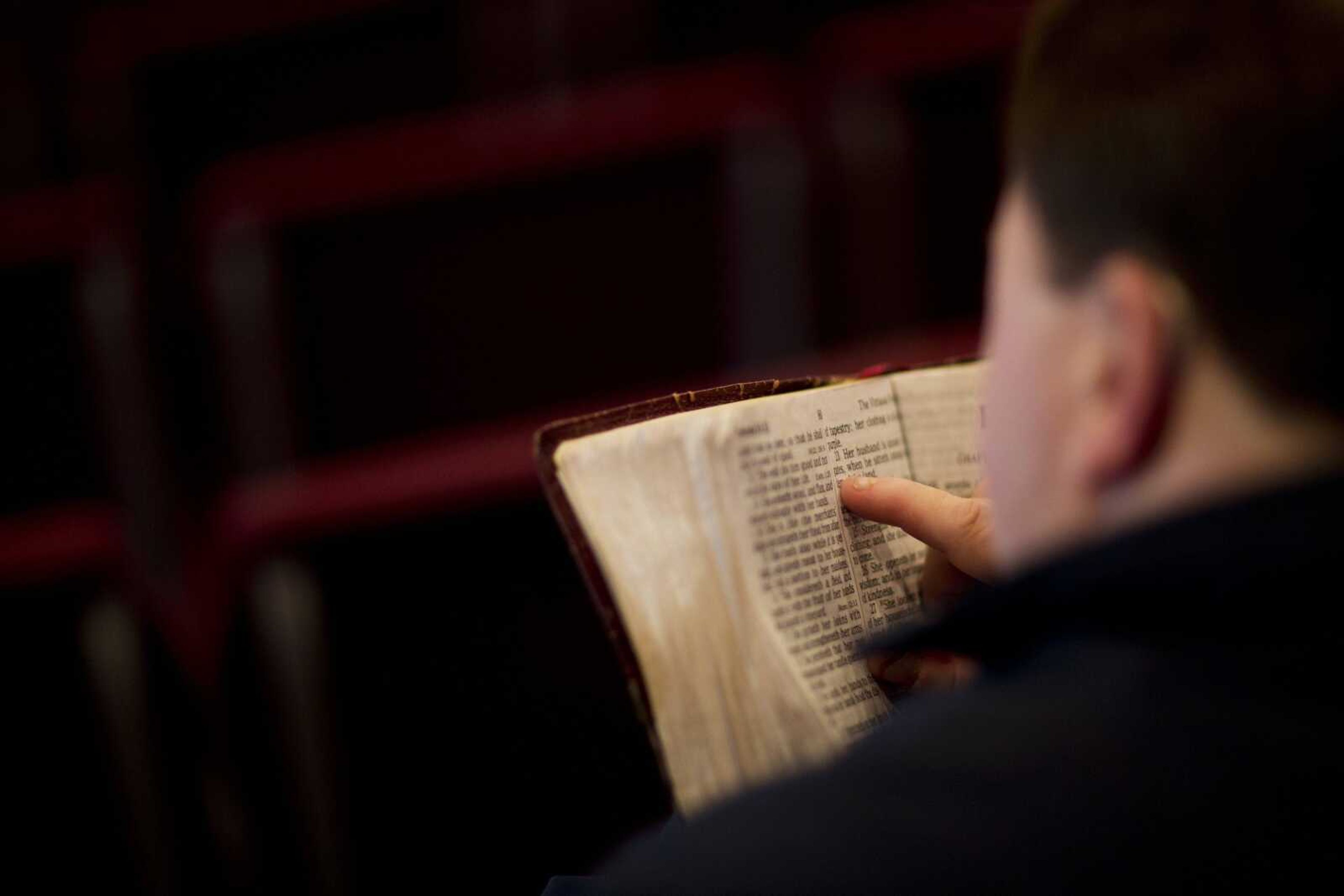 A parishioner reads the Bible before a service at the Christian Fellowship Church in Benton, Kentucky.