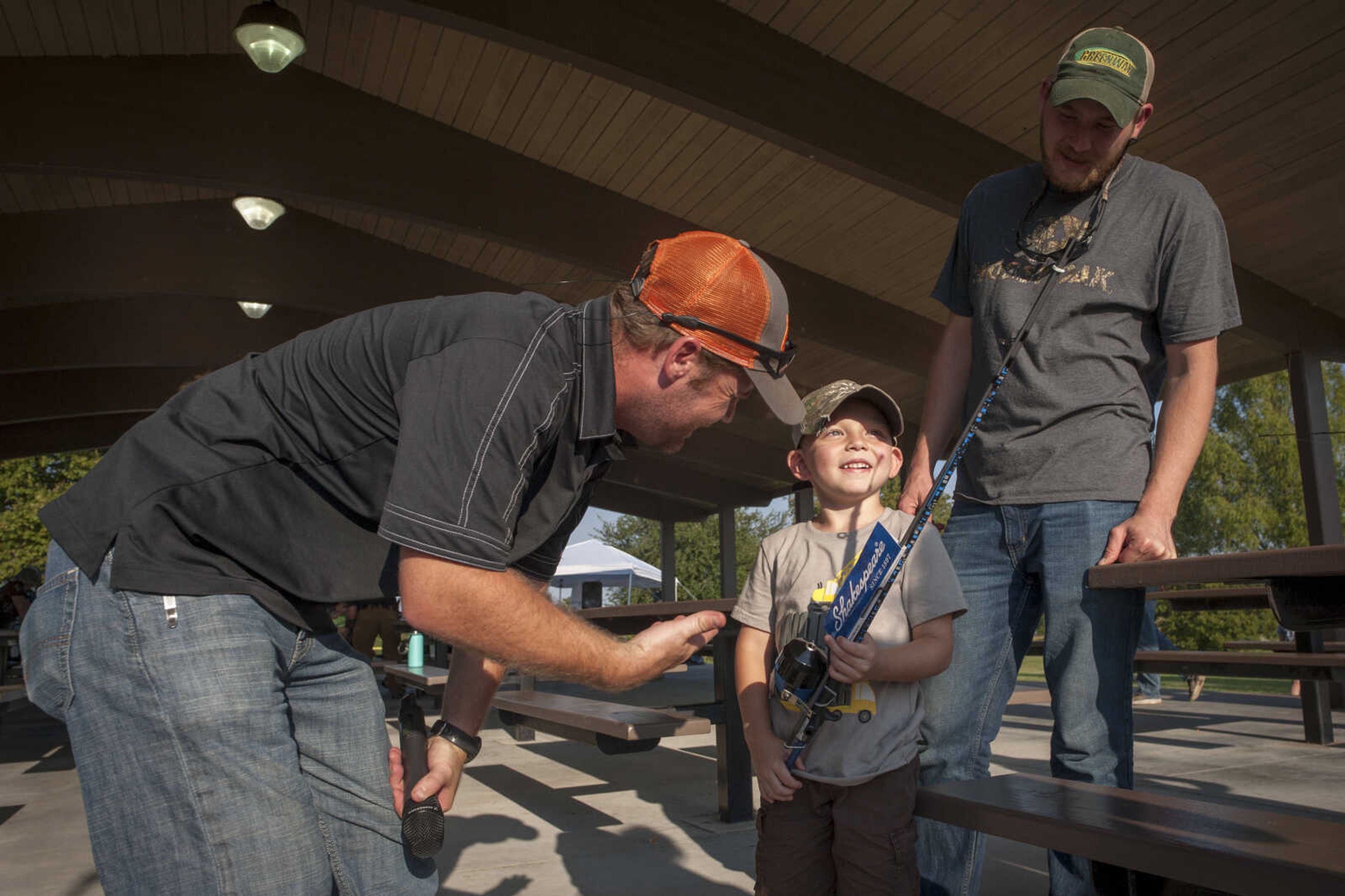 Tripp Brewer, 5, recieves a fishing pole from Fraternal Order of Police Lodge 51 president Bobby Newton on Sept. 29, 2019, at Cape County Park North. Brewer's parents said he has been fishing ever since he could hold a pole, and estimated he caught about 10 fish throughout the day.