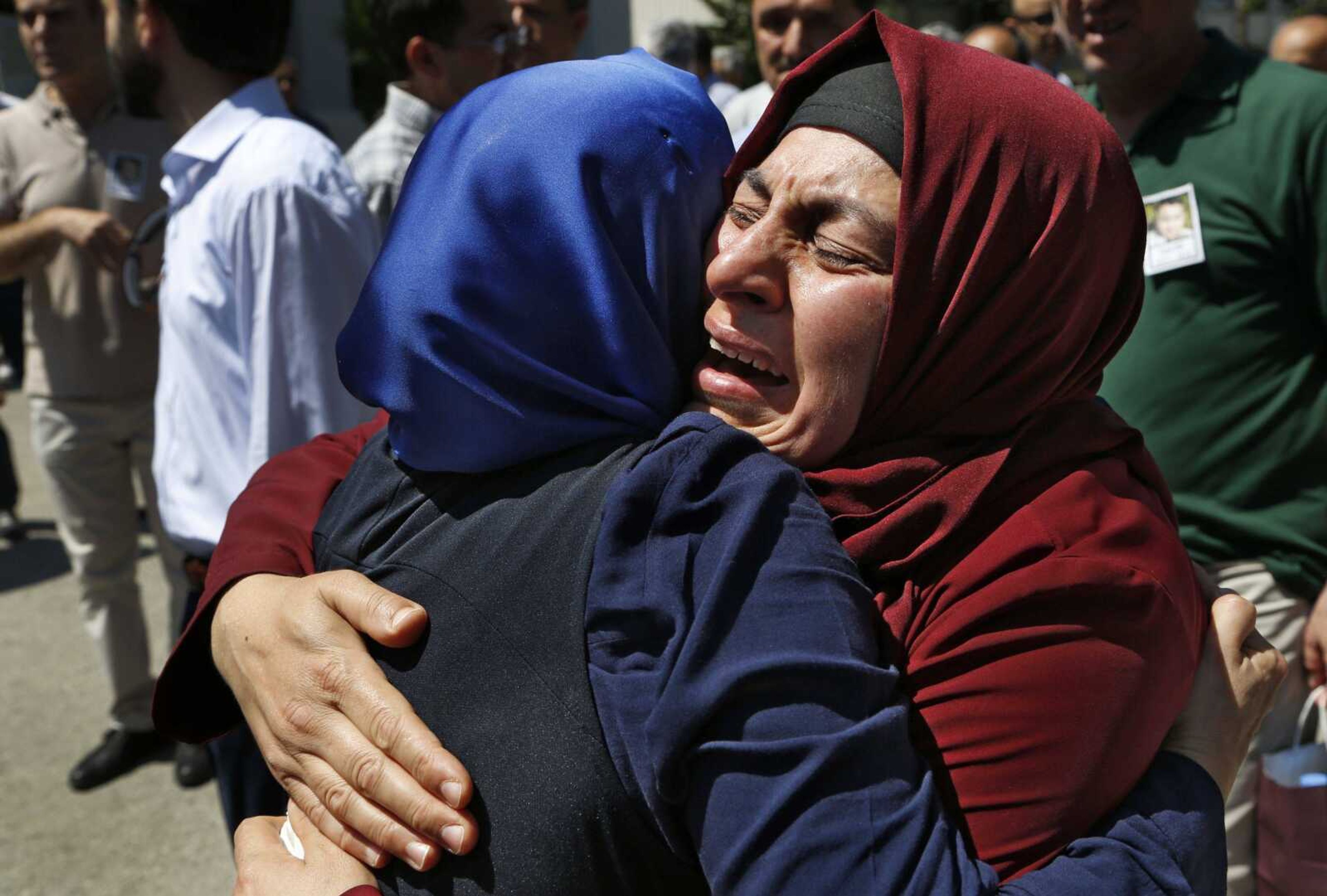 Relatives of Turkish geologist Cuma Dag, 39, who was killed by helicopter gunfire Friday while protesting against the attempted coup against Turkey's government, mourn during his funeral Sunday in Ankara, Turkey.