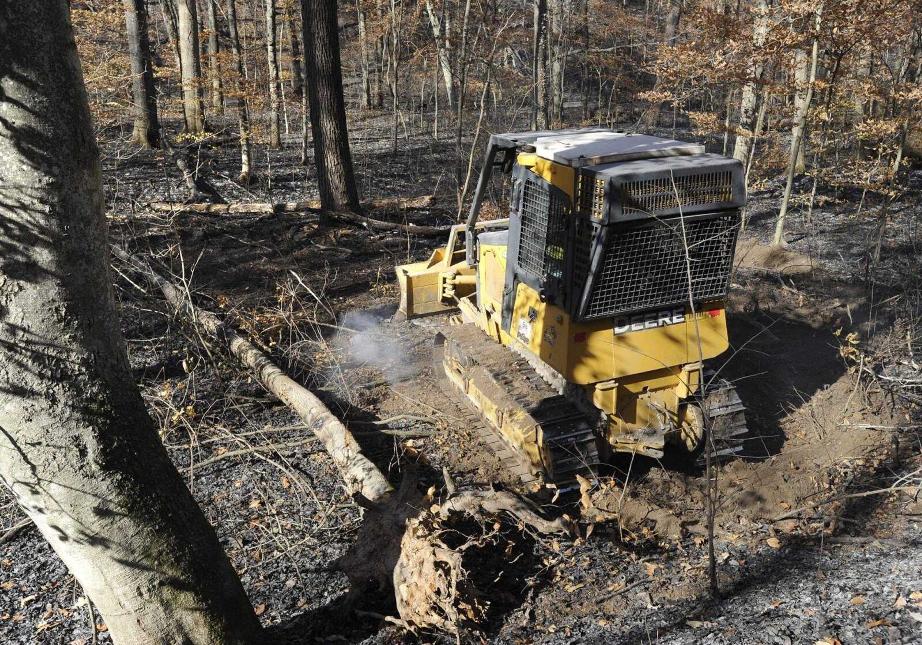 A bulldozer continues the mop up of a forest fire at Shawnee National Forest on Wednesday, Nov. 10, 2010. The fire began from an adjacent field on Monday. (Fred Lynch)