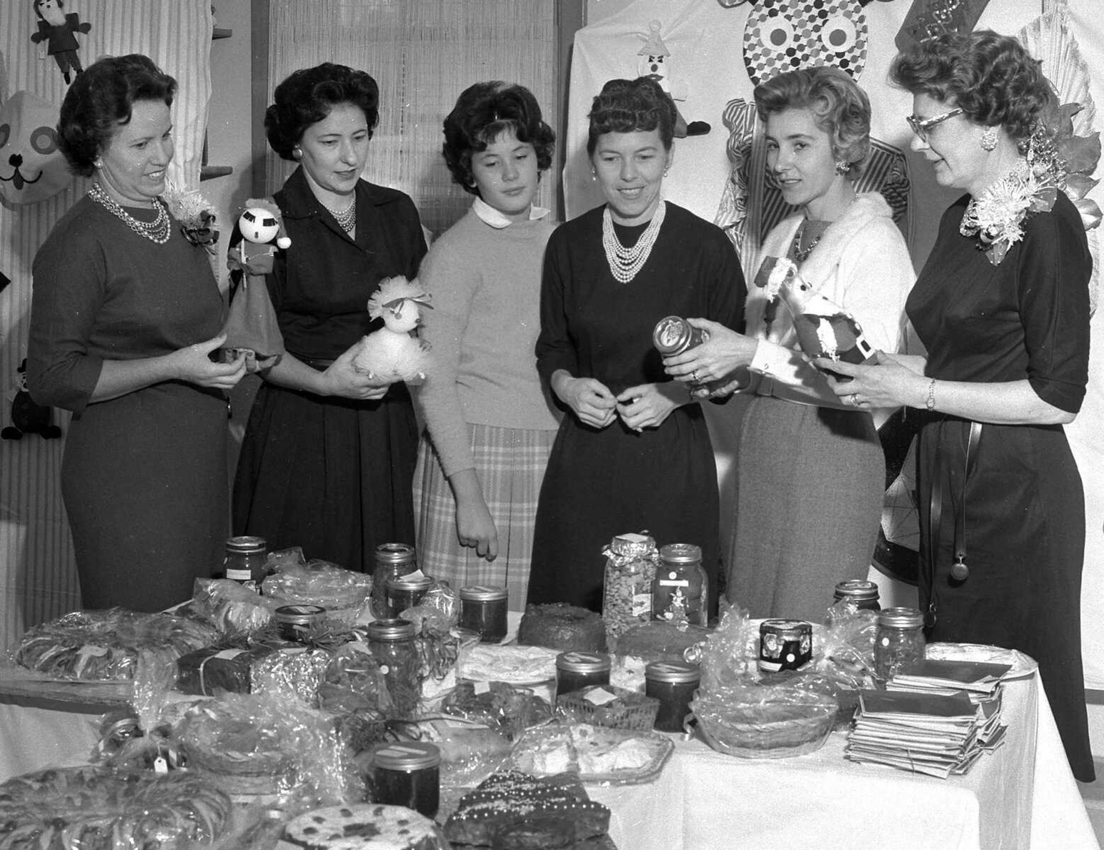 These unidentified women look over the delicacies offered at a bake sale. If you can provide information about this image, contact librarian Sharon Sanders at ssanders@semissourian.com.