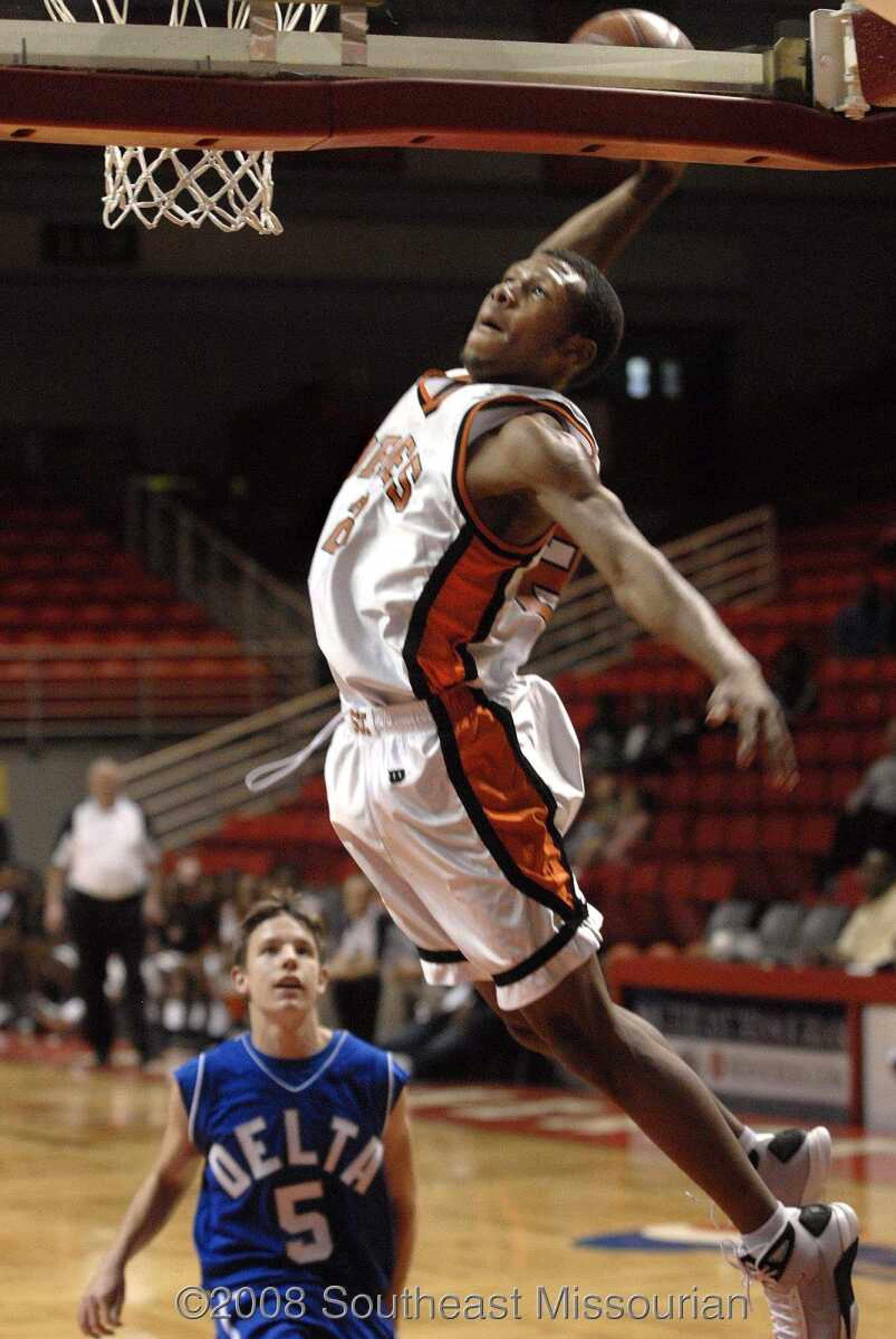 FRED LYNCH ~ flynch@semissourian.com
Scott County Central's Drew Thomas prepares a slamdunk as Delta's Cody Helderman watches during the second quarter of their first-round game in the Southeast Missourian Christmas Tournament Friday at the Show Me Center.