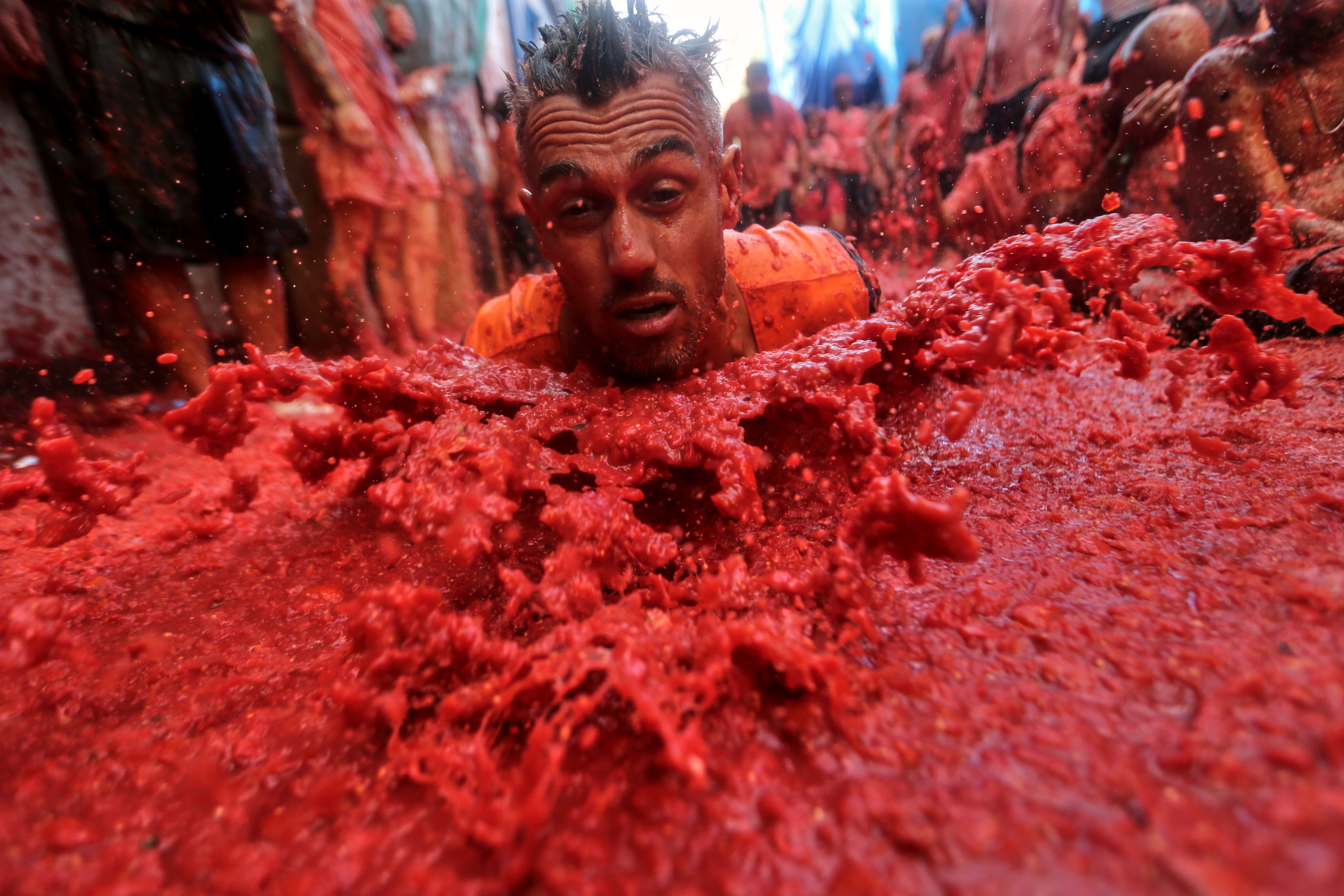 Photos show revelers pelting one another with tomatoes at Sp